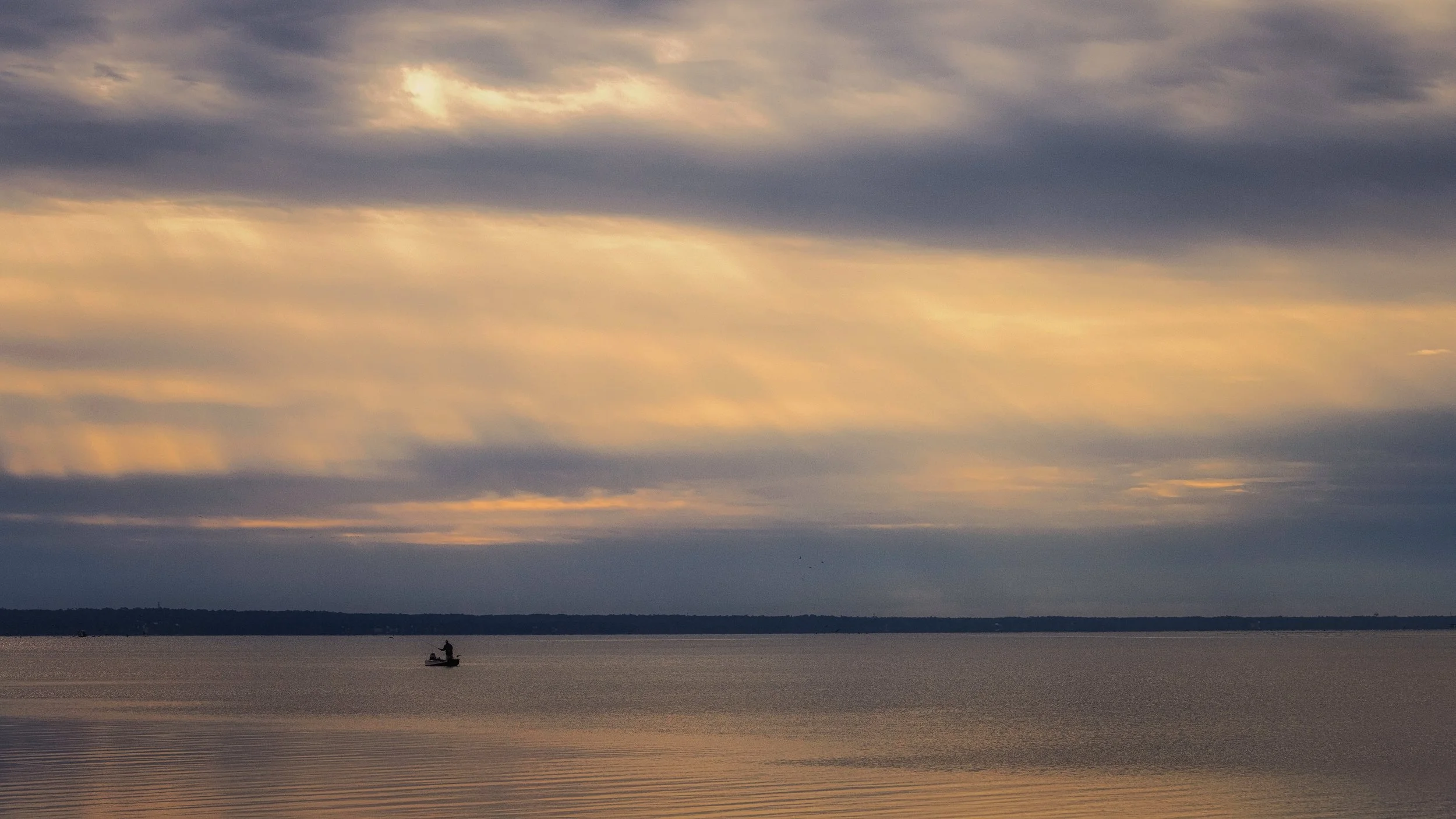 solo-fishing-mobile-bay-sunset-golden-rays.jpg
