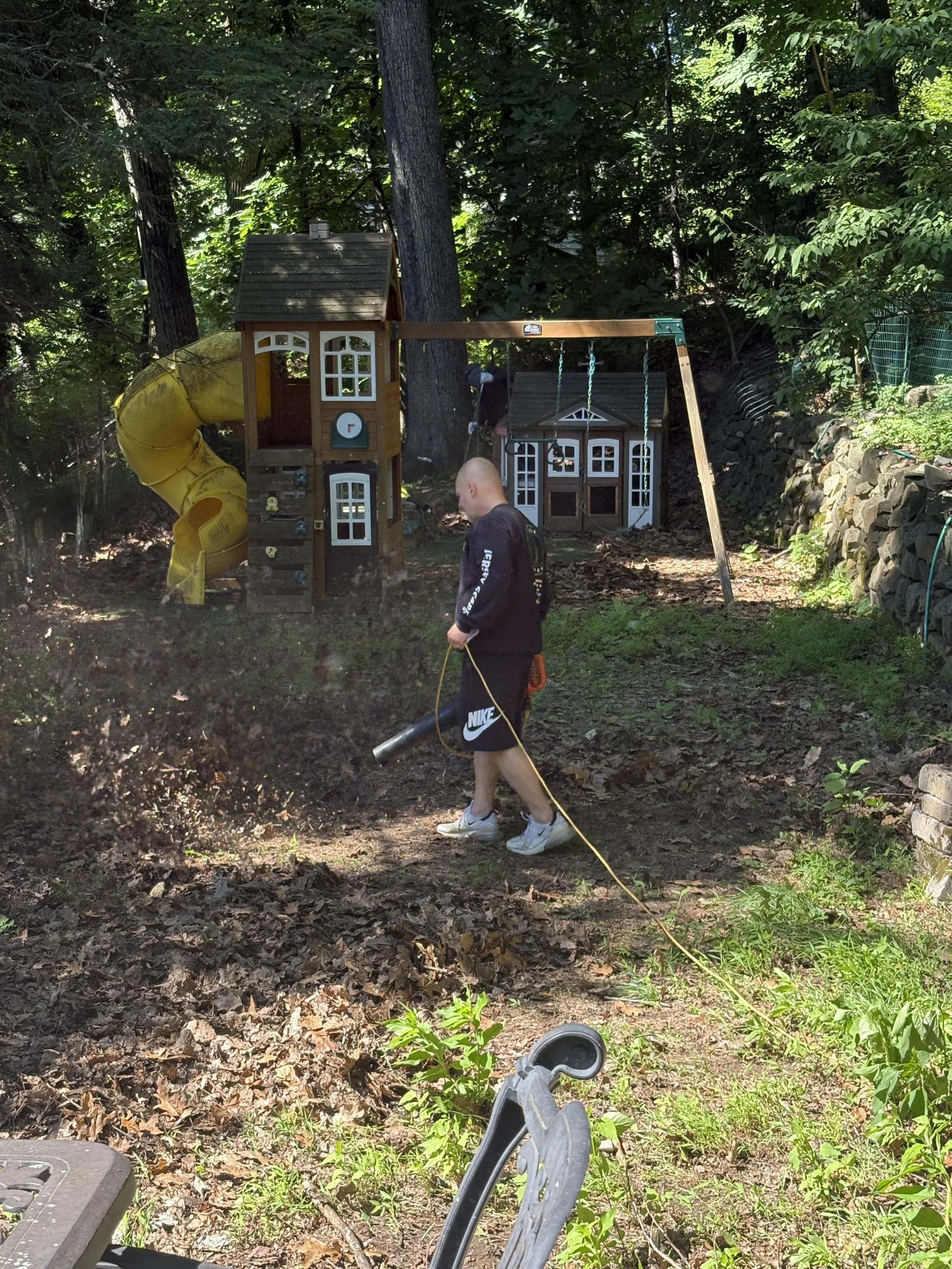 Full before photo of this yard. It has not been maintained at all, totally covered in leaves, not a safe or inviting space for the family. Work done in Upper Montclair, NJ.