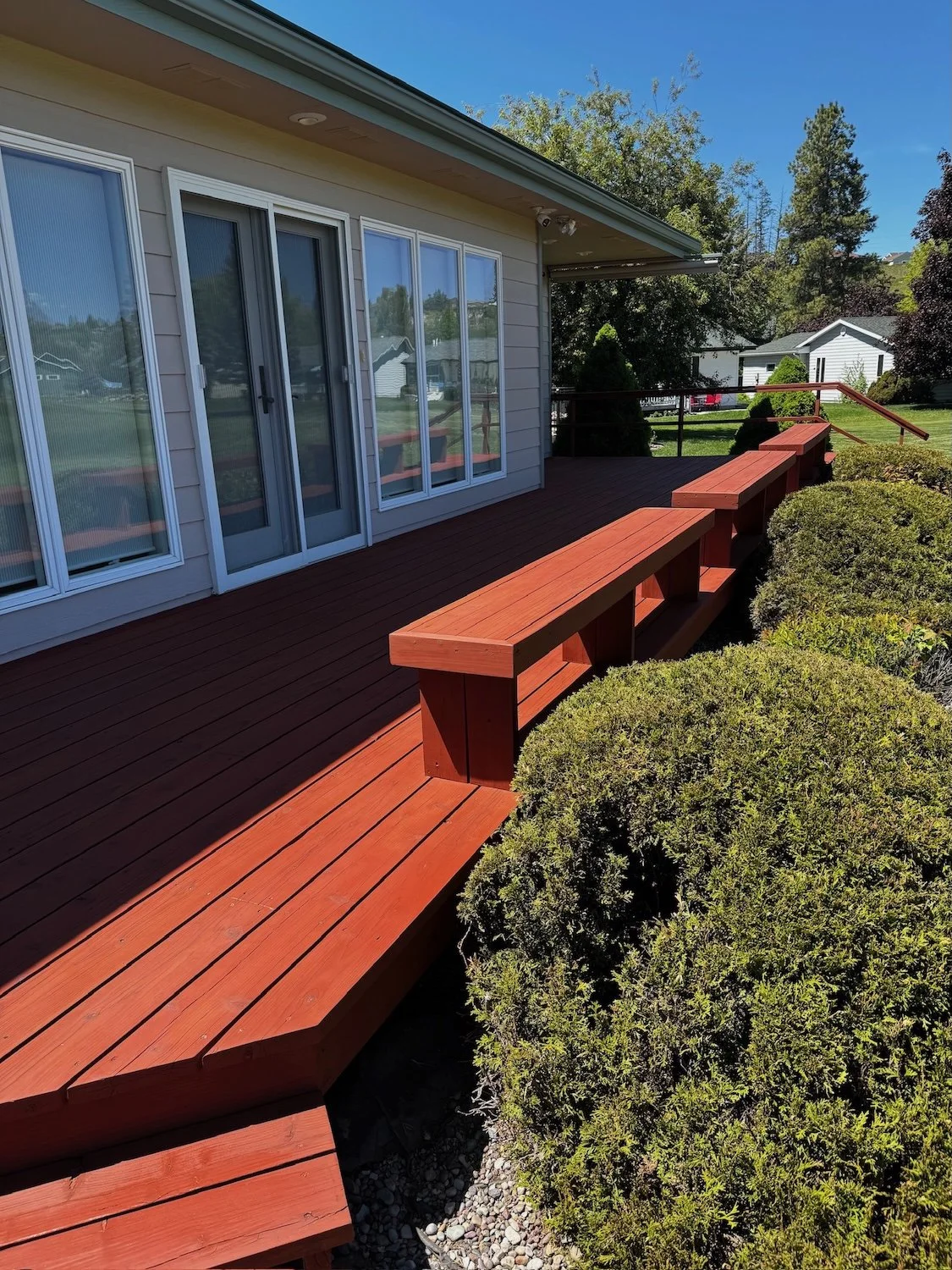 after image of freshly red stained wood deck