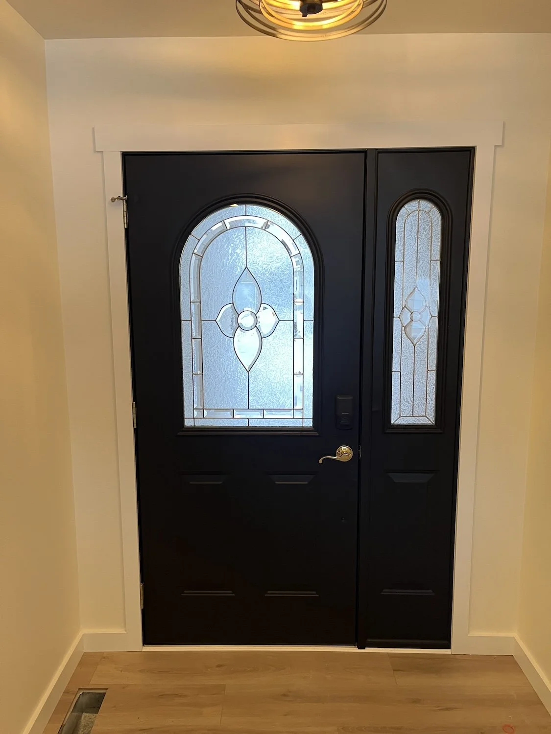 black painted front entry door with white trim