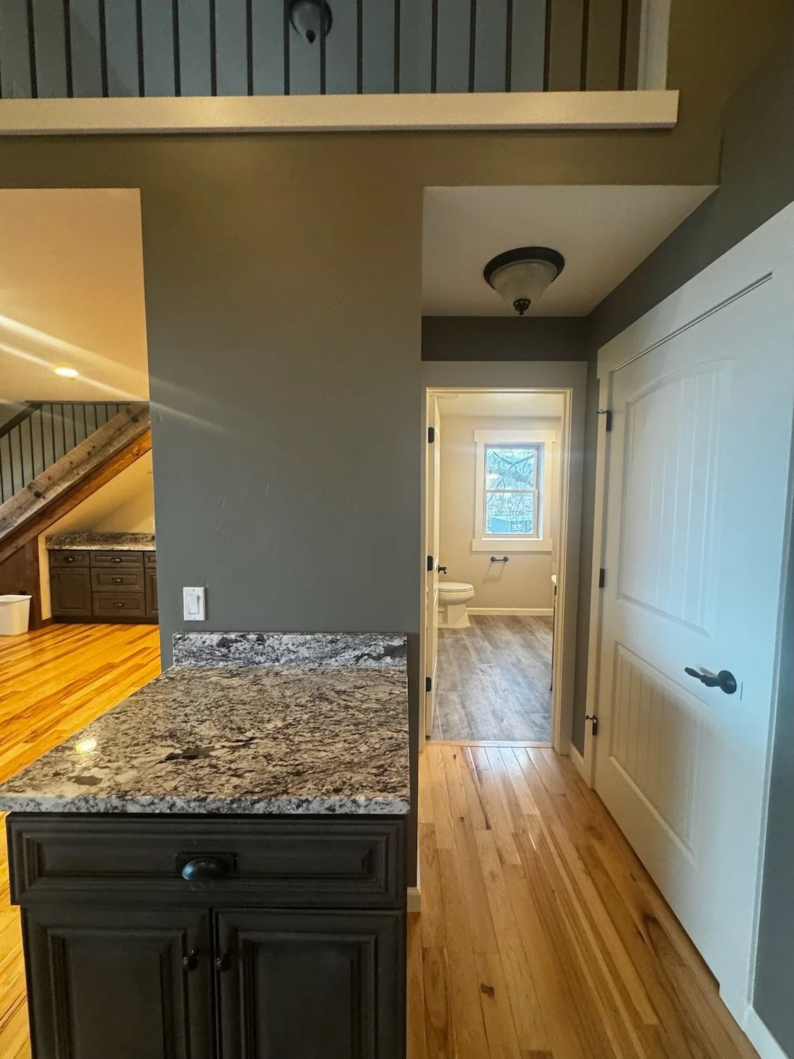 green interior repaint with white trim, marble countertop, and white closet door