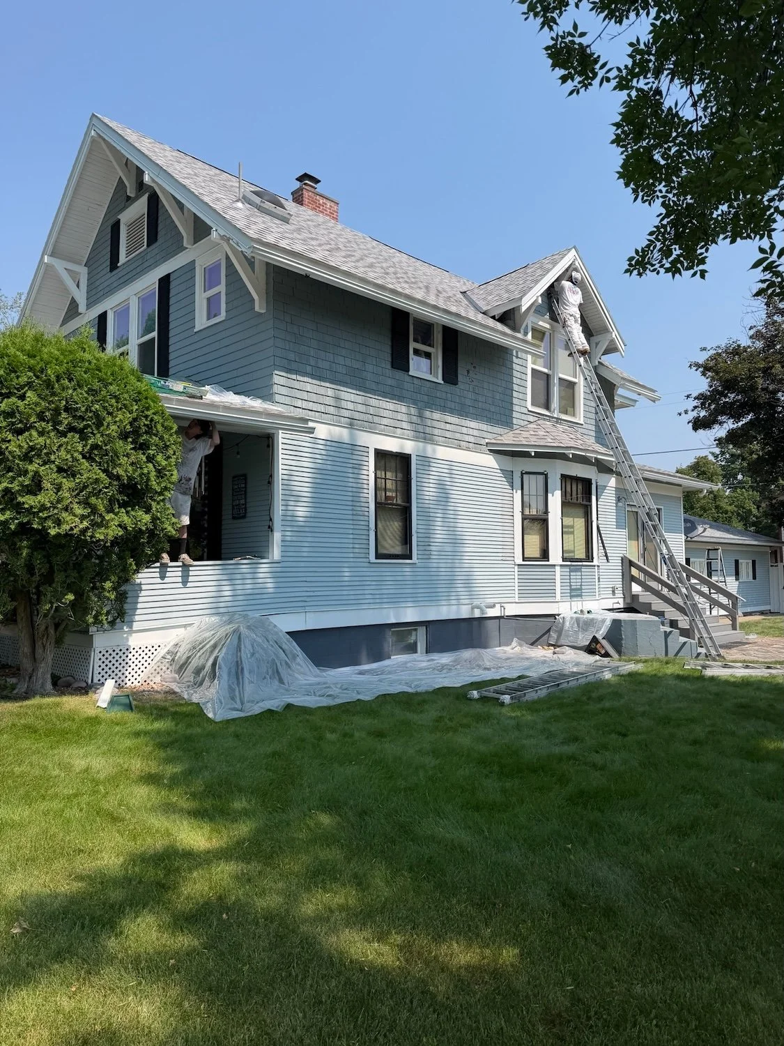 Painting crew working on exterior repaint of historic Montana home