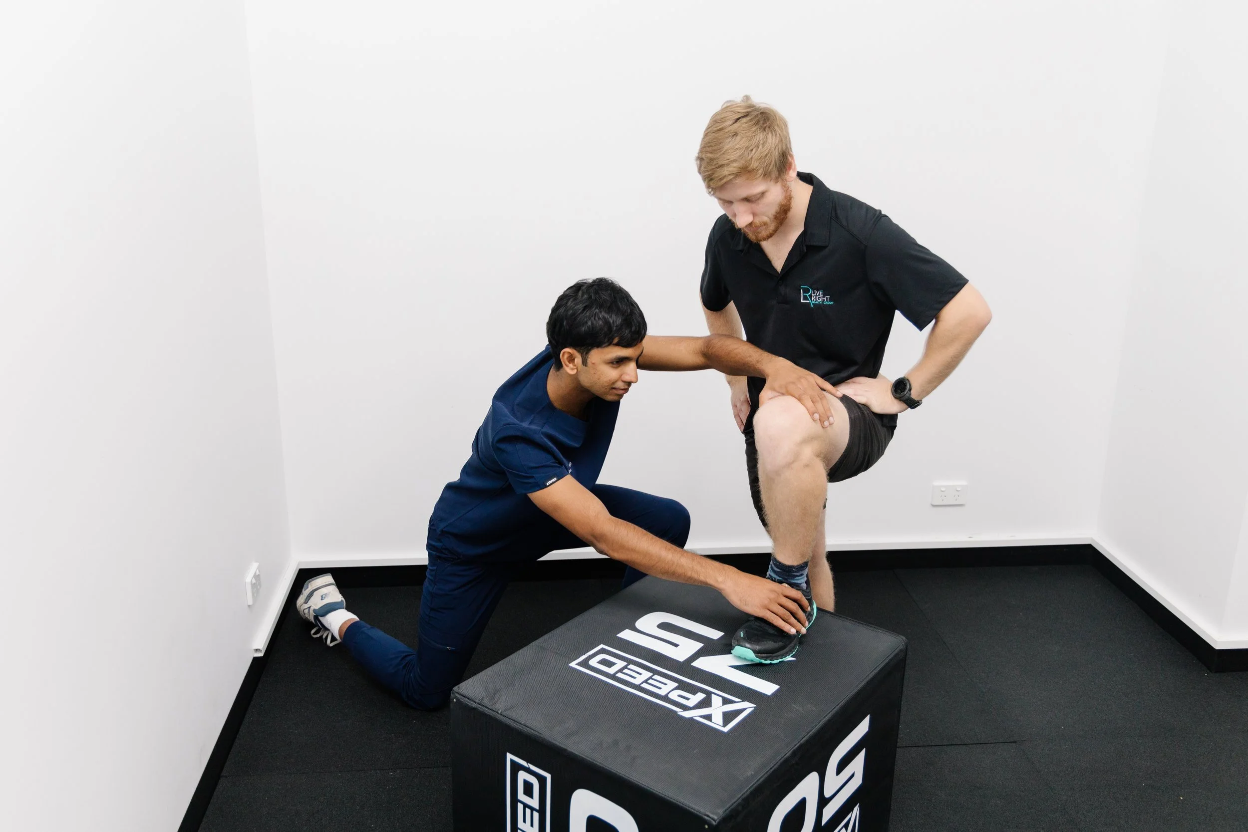 Physiotherapist assessing knee flexion during sports injury rehabilitation at Move Right Physio Dakabin