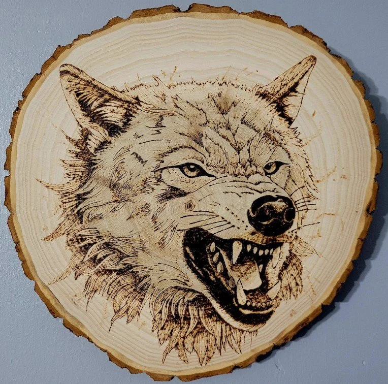 Jadyn Deming.
Alpha Predator, 2025
pyrography on wood
9" diameter
$160