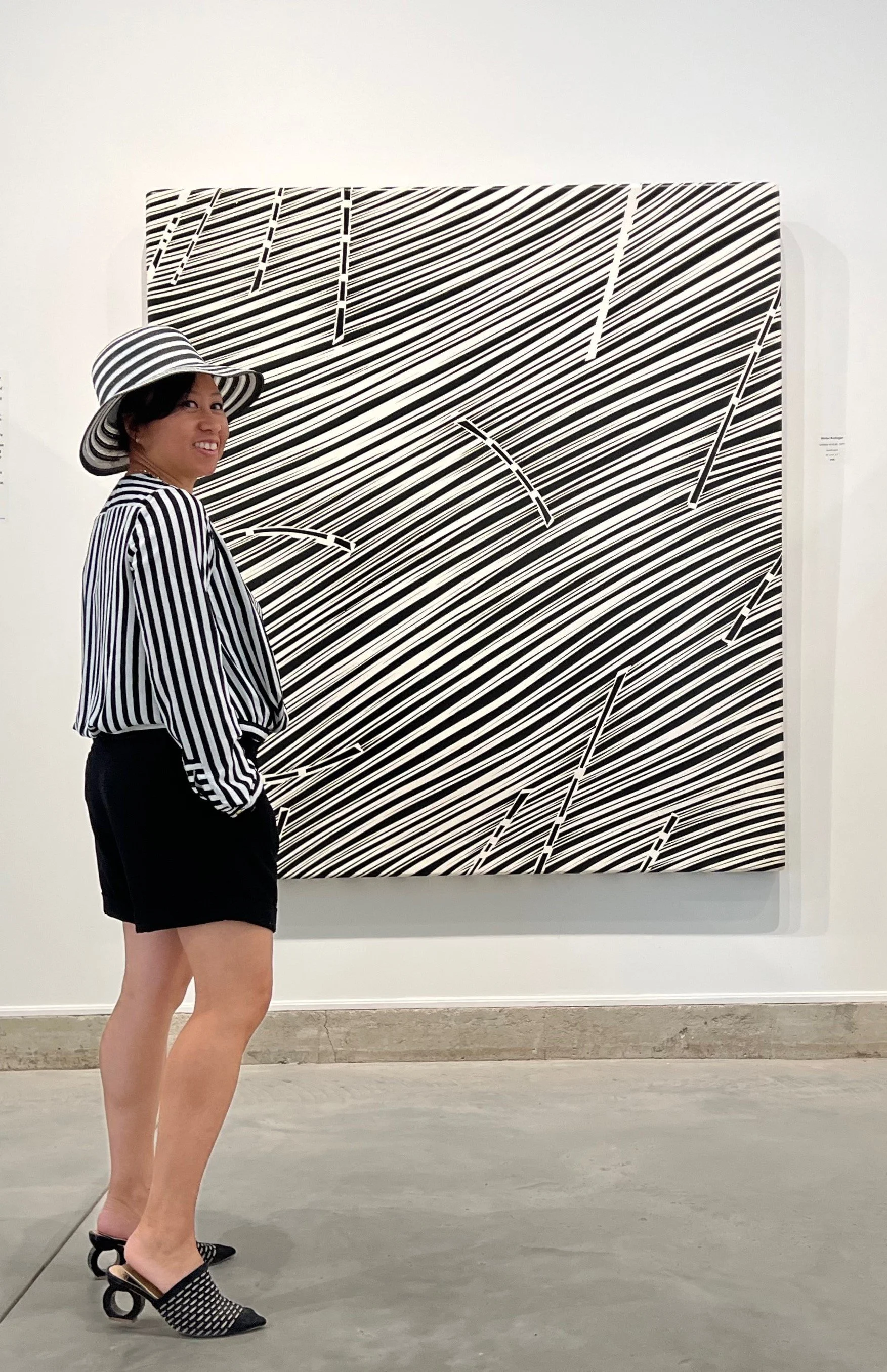 Curator Margie Galita in front of work by Walter Redinger at the John Mann Gallery