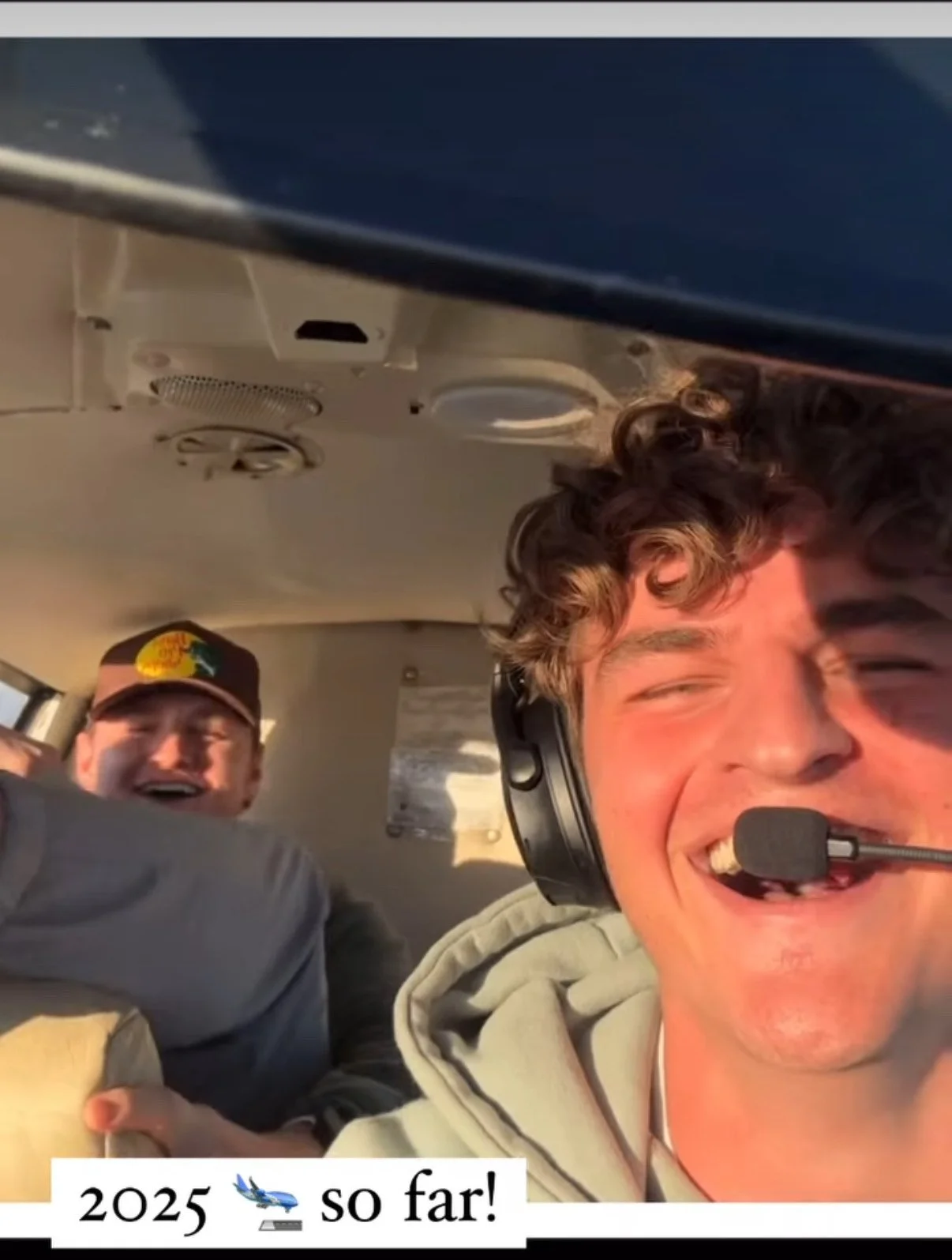 Two people smiling inside a small aircraft, one wearing a headset and microphone. Text at the bottom reads "2025 so far!" with airplane and trophy emojis.