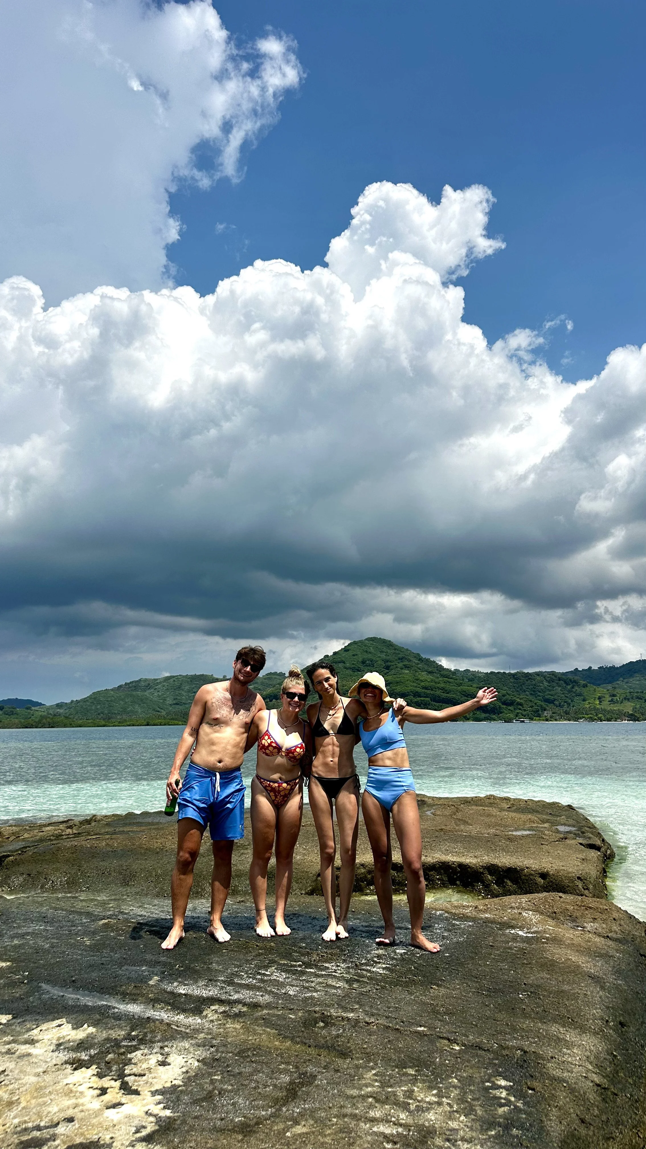 Group of travellers posing on the beach at Gili Kedis in Lombok