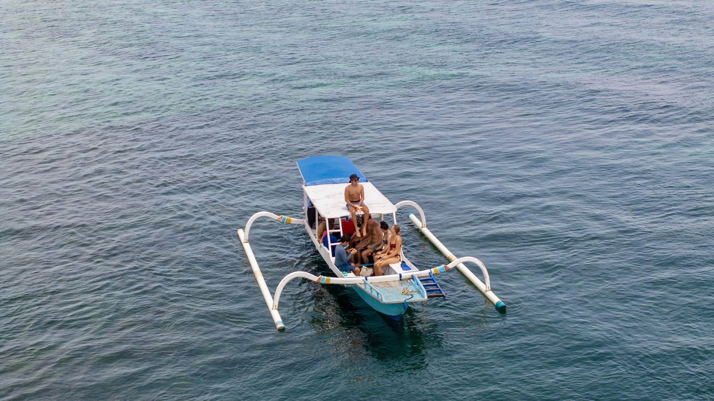 Guests travelling by traditional outrigger boat during a Gilis tour in Lombok