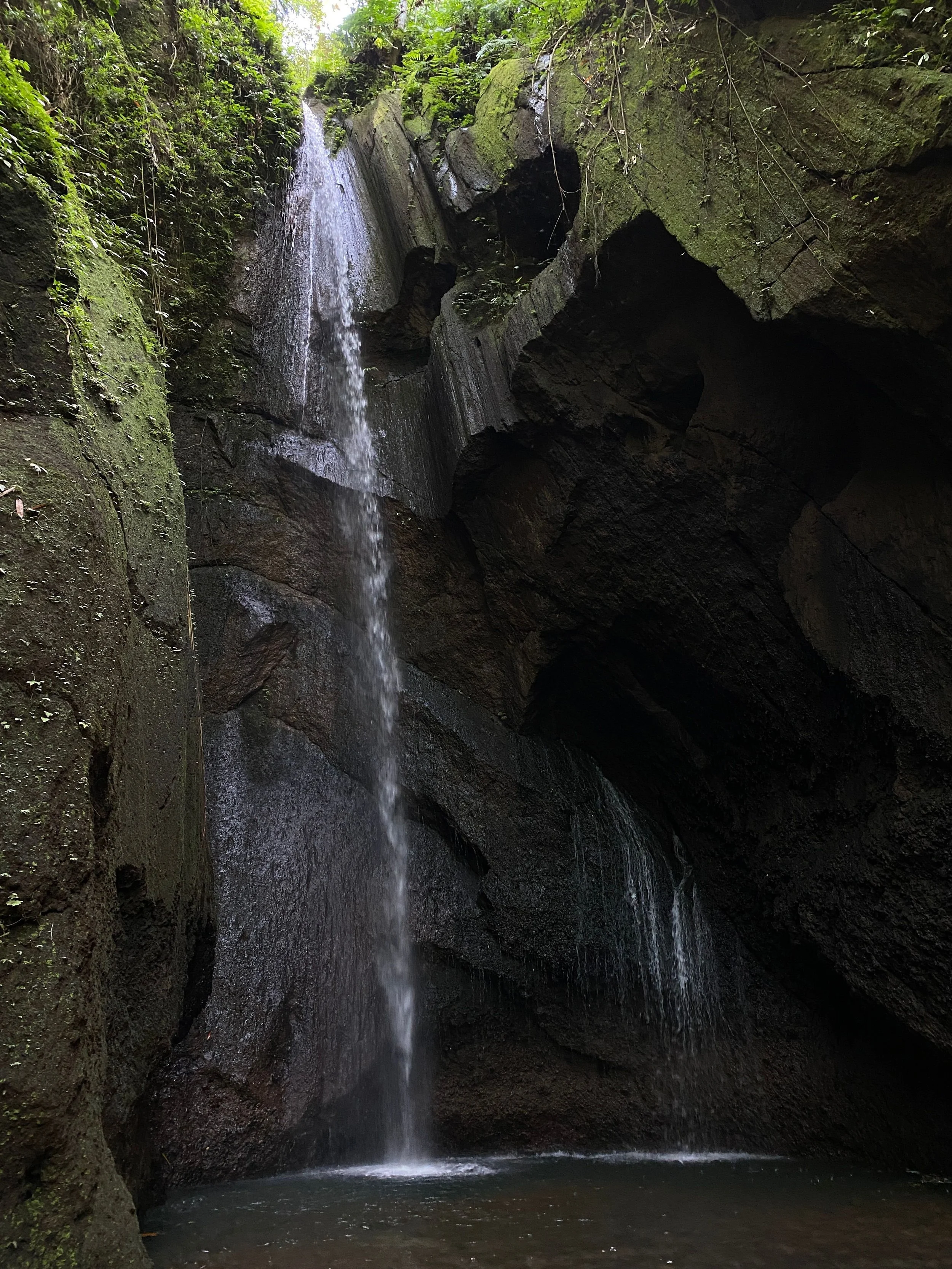 Hidden waterfall surrounded by jungle near Tetebatu in Lombok