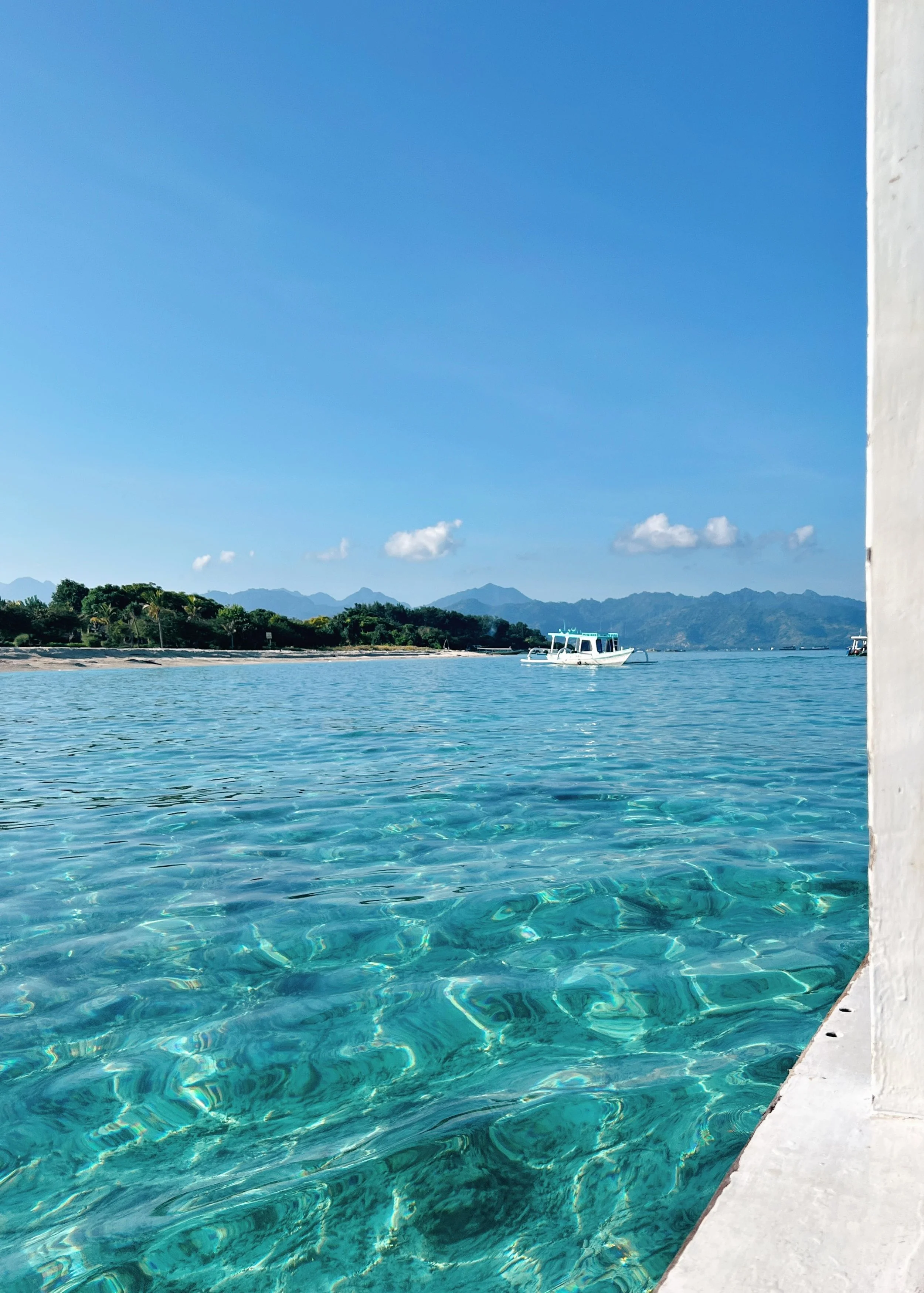Tropical island coastline and calm blue sea in Lombok