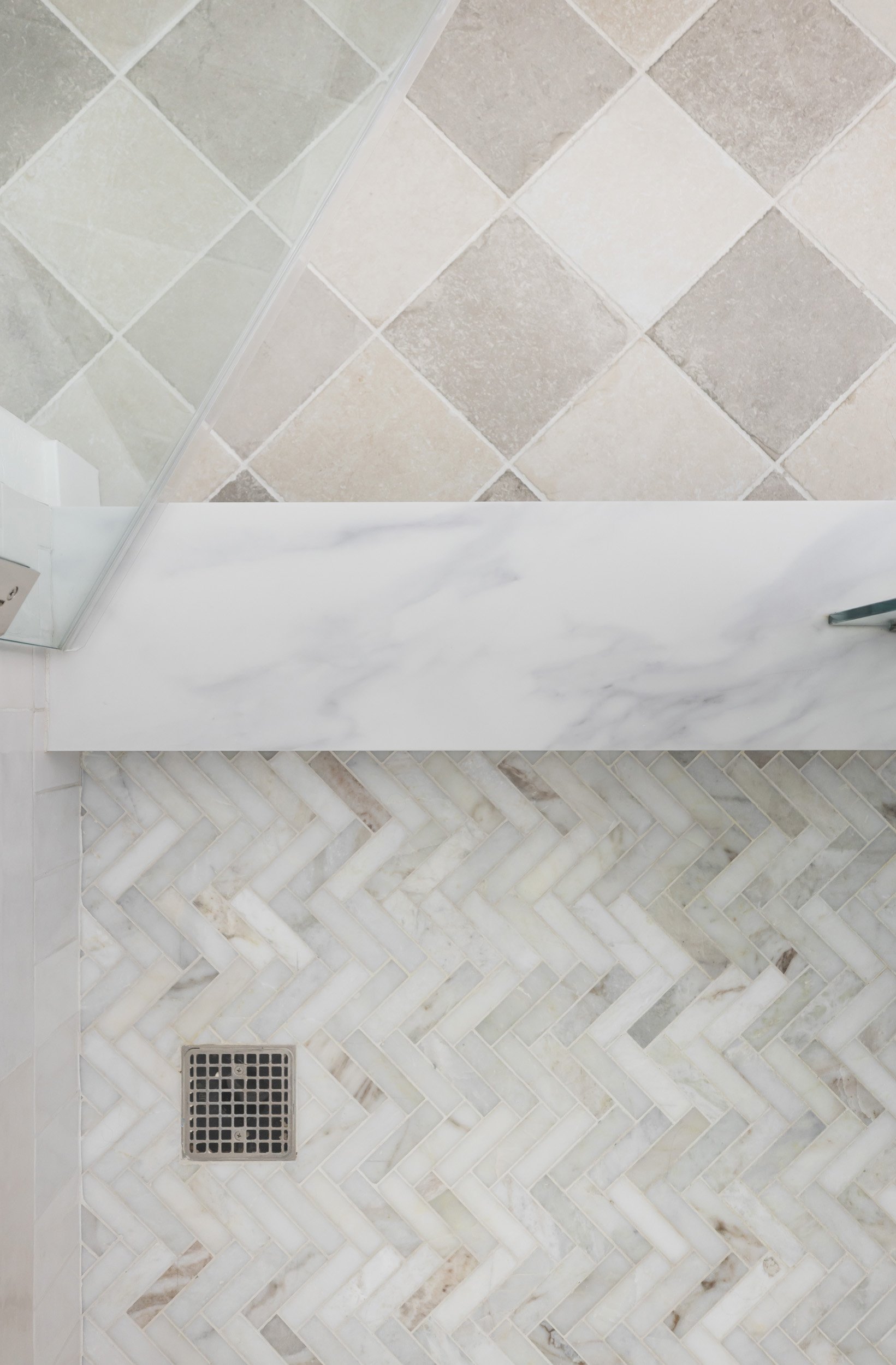 Herringbone marble shower floor and diamond-pattern wall tile, Phoenix primary bathroom