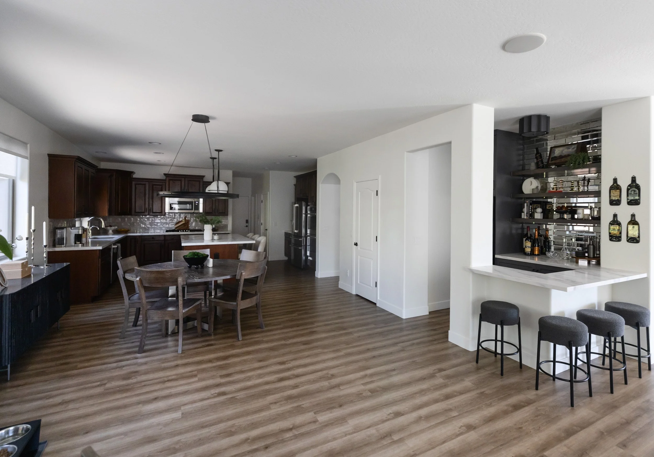 Open plan living area with wine bar, counter stools and dining space in Desert Ridge, Phoenix
