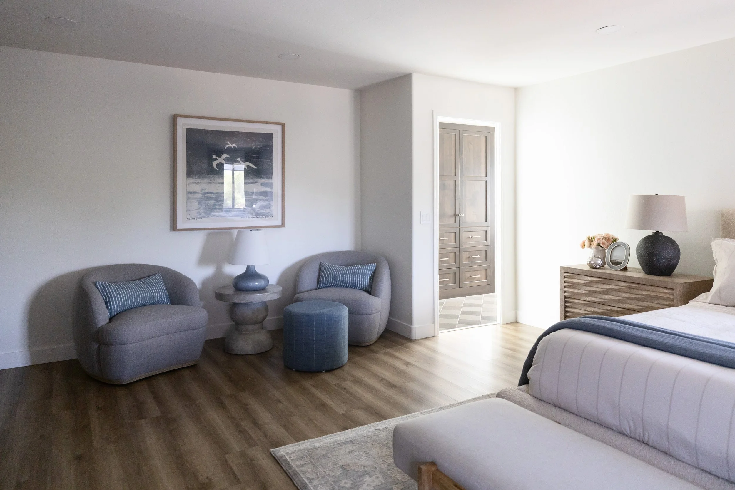 Primary bedroom seating area with blue chairs and a view into the bathroom, Phoenix