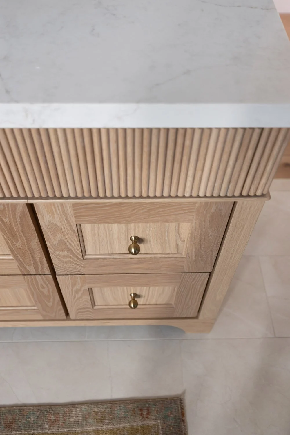 Close-up of oak vanity drawer detailing and fluted edge profile in Scottsdale home