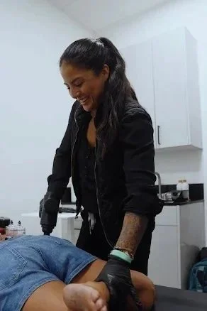 Dr. Ashley Aguero, DC, treating a runner's leg and knee at ELATE in North Park