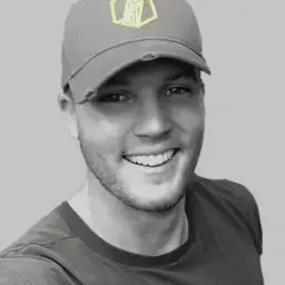 Smiling young man wearing a baseball cap and casual T-shirt