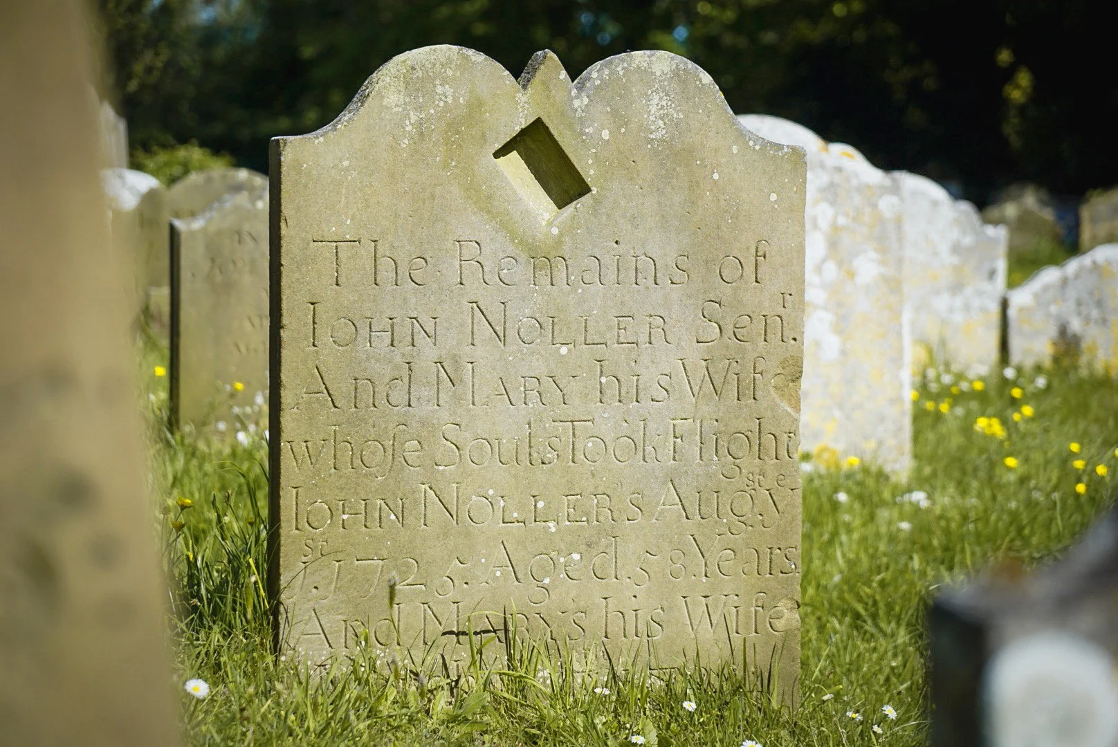 The remains of John Noller Senior and Mary his wife, with recessed sundial. St John, Saxmundham, Suffolk.