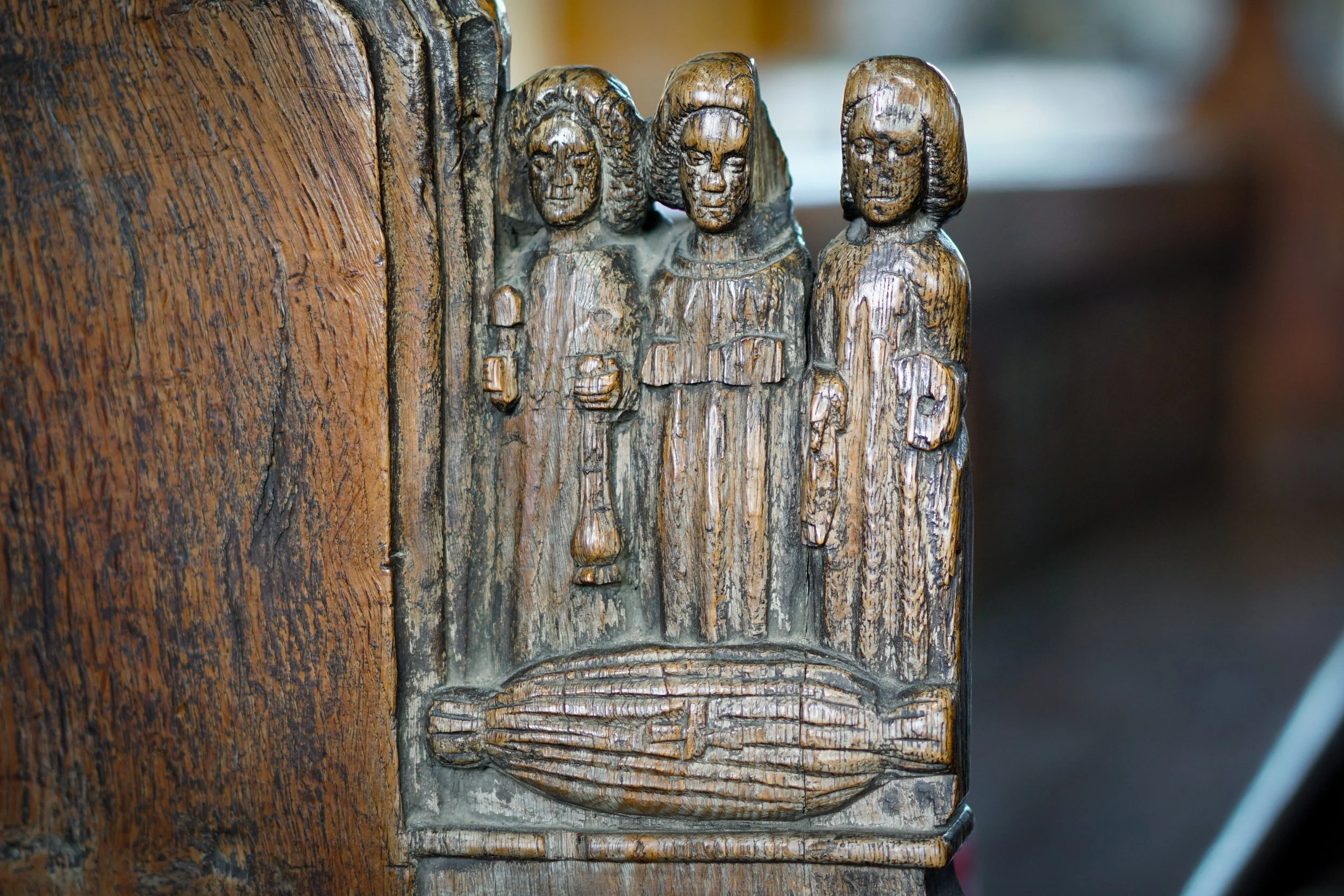 Bench end burial. St Mary, Feltwell, Norfolk.