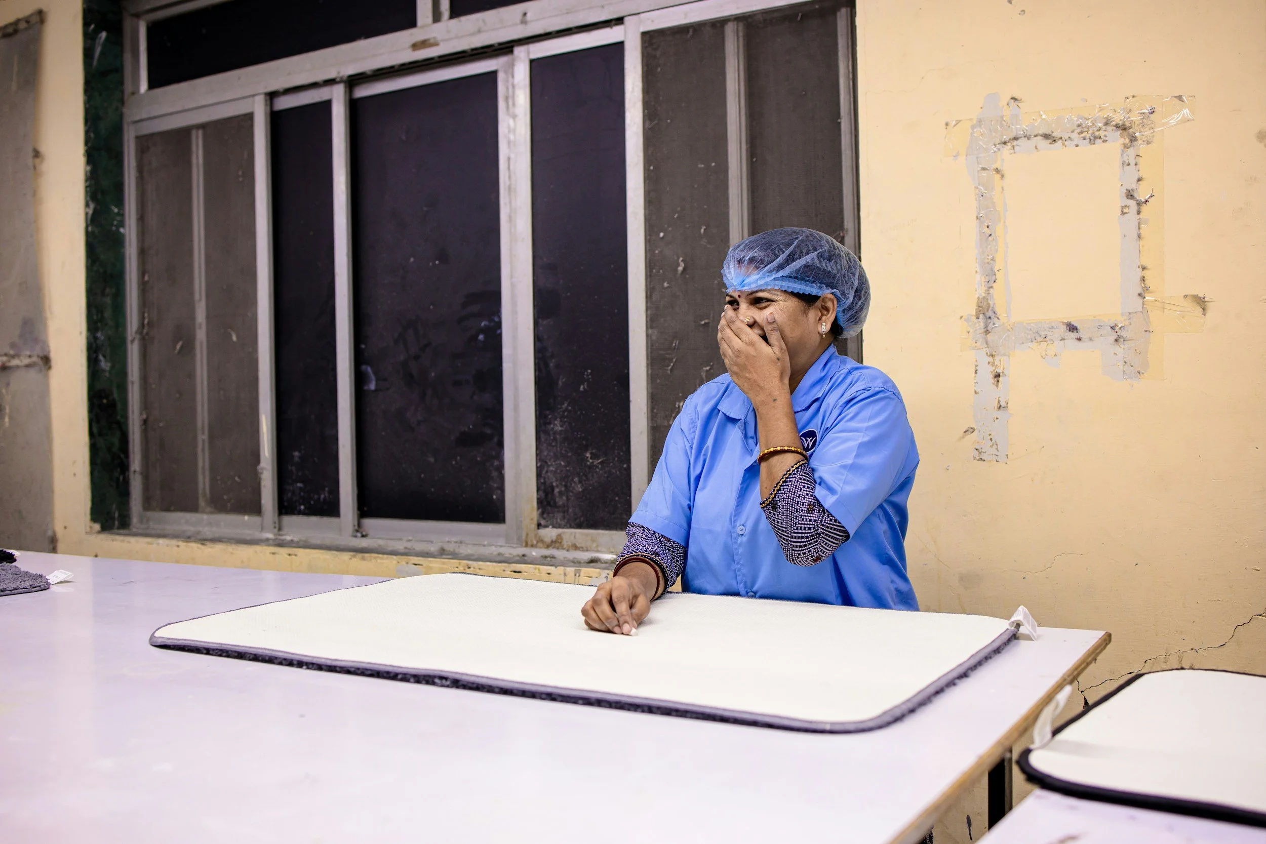 Production floor supervisor speaking with a team member.