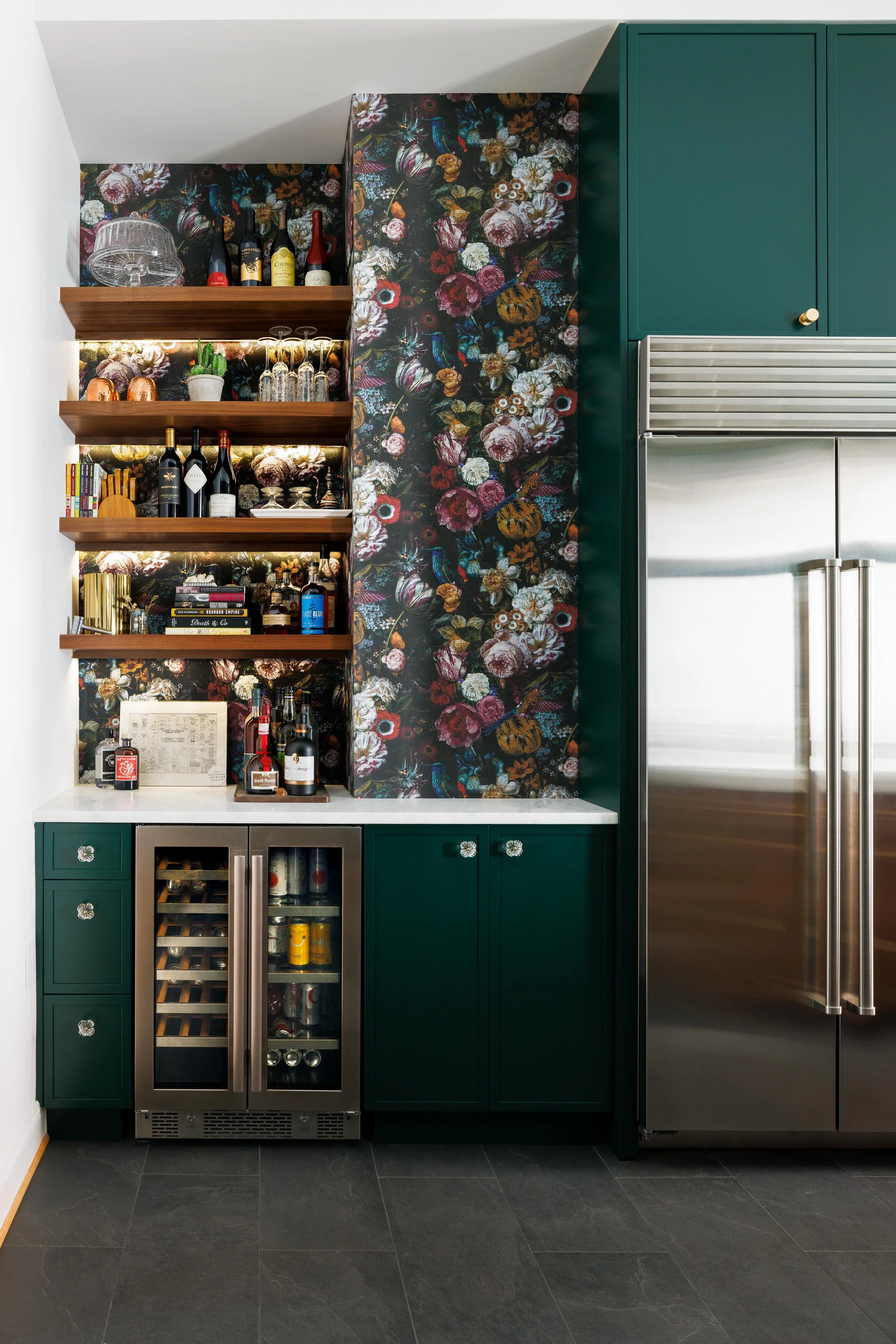 I helped transformed a cramped, walled‑off kitchen and dining room into a unified, social hub complete with an island, breakfast bar, and dry bar. Bold, emerald floor‑to‑ceiling cabinetry—offset by stained walnut floating shelves and exposed brick—ma