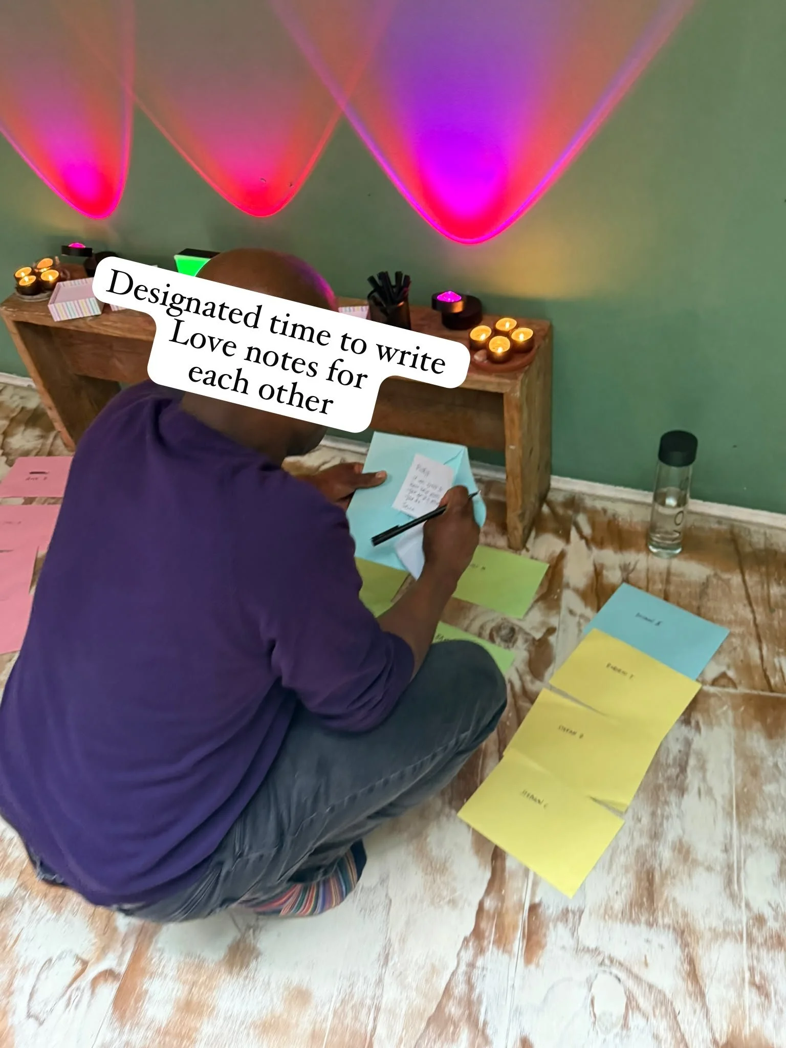 Gay man at a speeding event in London writing love notes on paper.