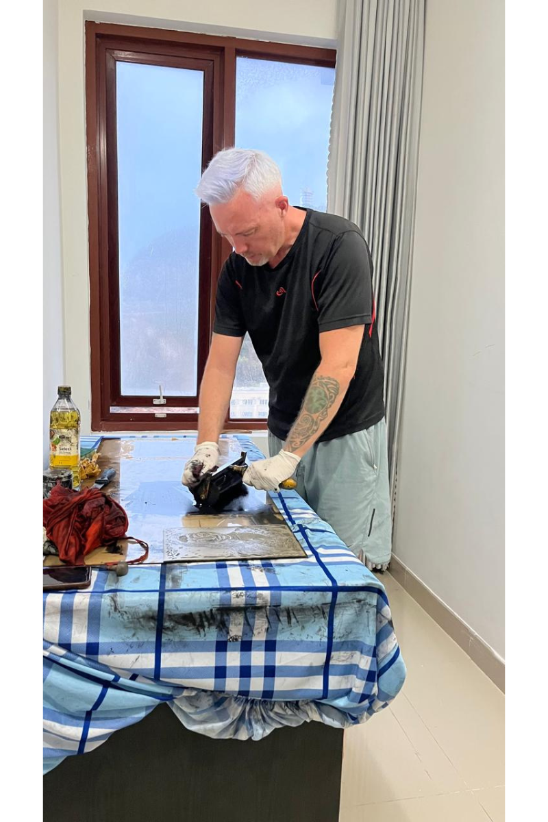 Printmaker Mark James Murphy in his home studio cleaning brayer