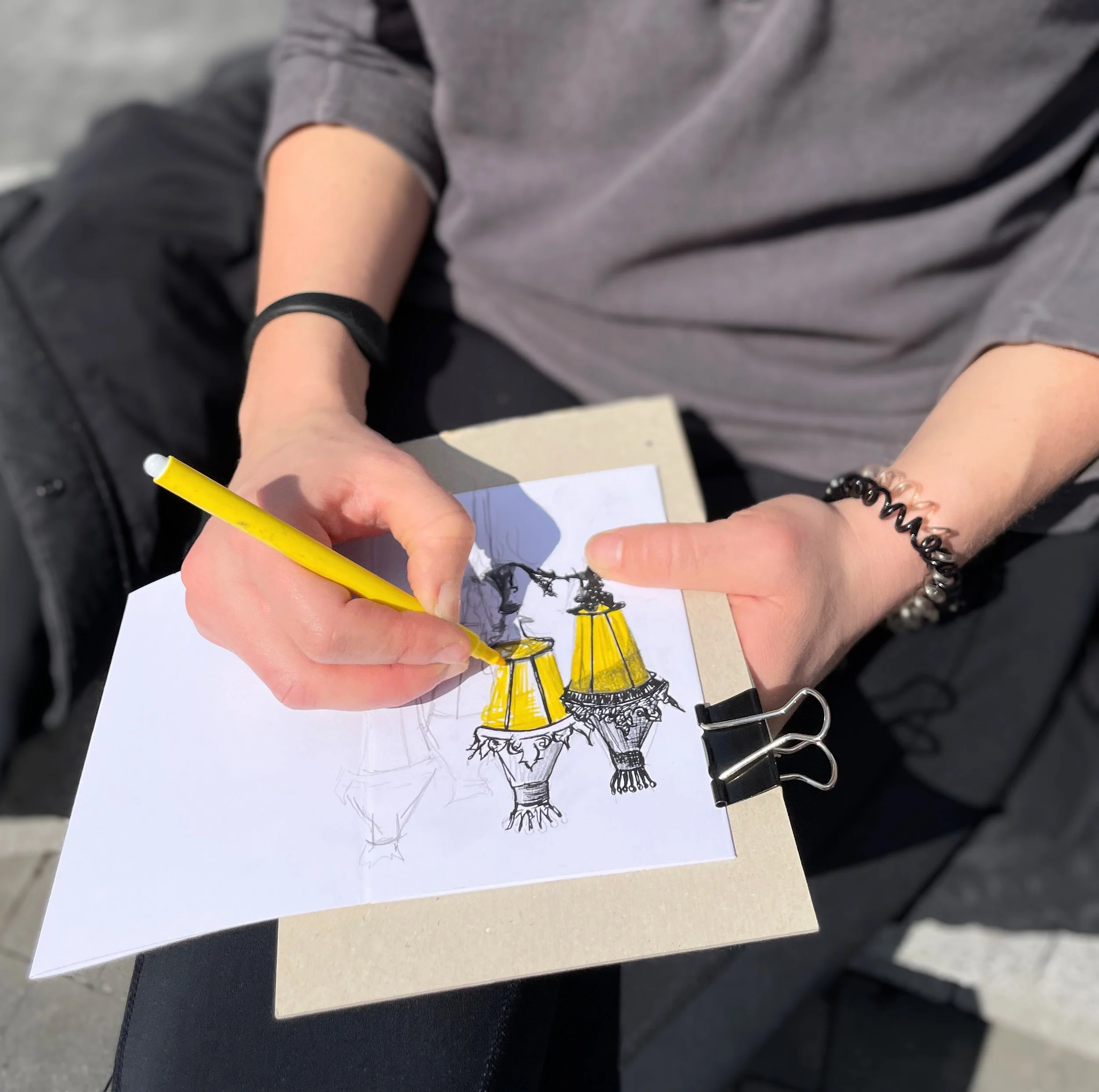 Sketching details of the city's street lights. Focus in on one feature and capture it as a memento of your trip.