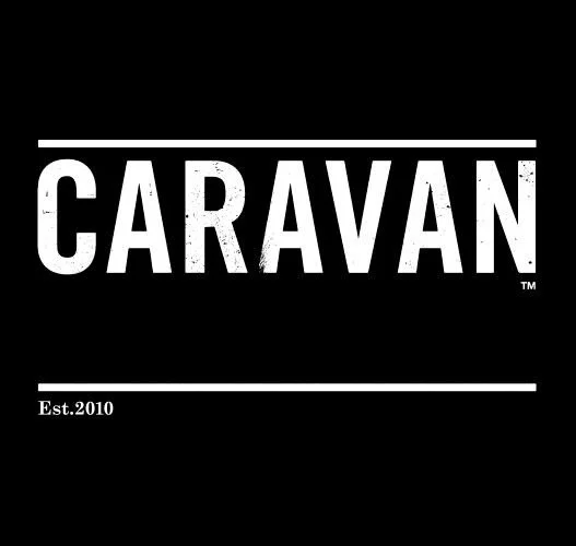 A black background with the word 'CARAVAN' in bold white letters, with 'Est. 2010' written below.