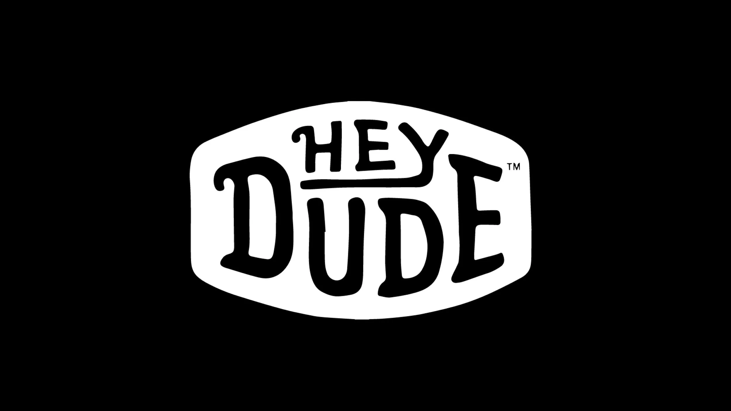 Black background with white oval-shaped logo reading 'Hey Dude' in stylized text.