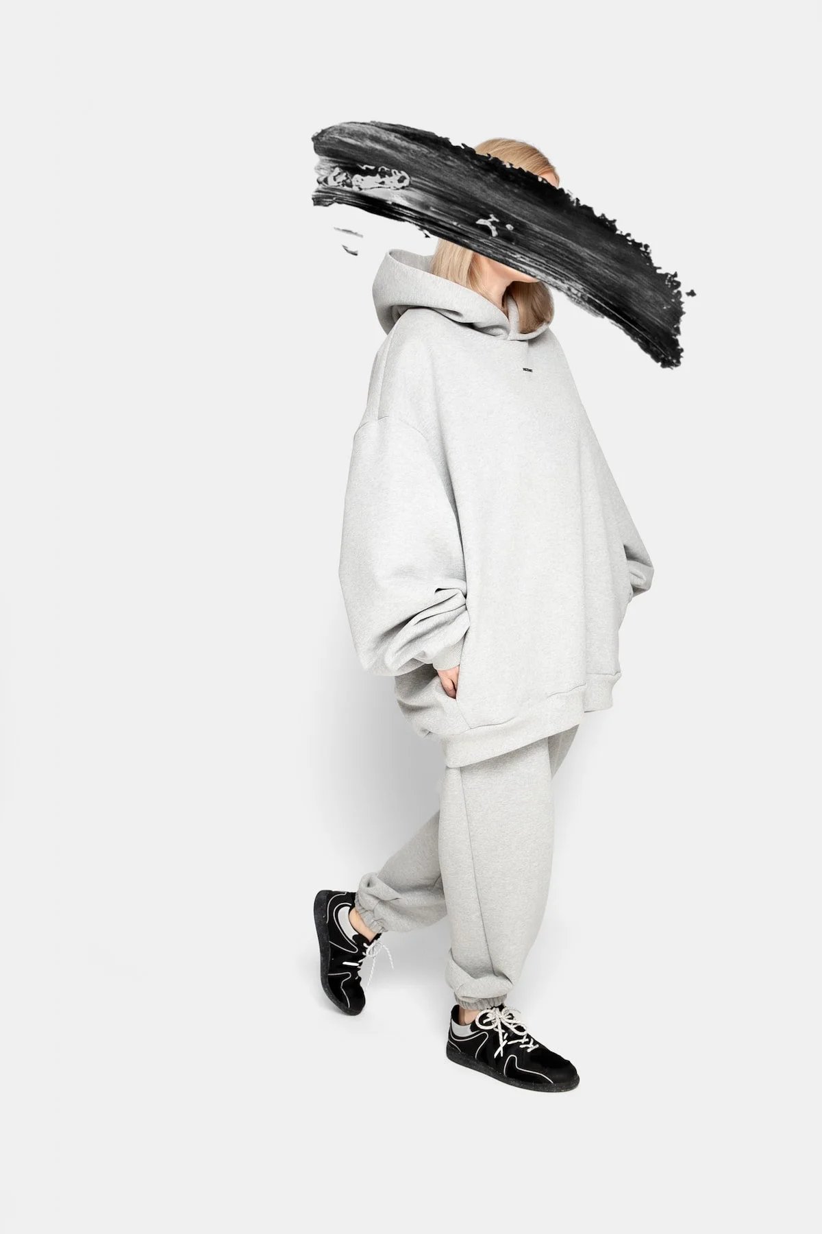 Model wearing REZON8T ESSENCE Collection premium oversized hoodie and sweatpants in grey, made from 100% French terry cotton. Designed in Denmark, crafted in Europe — limited-edition minimalist streetwear.