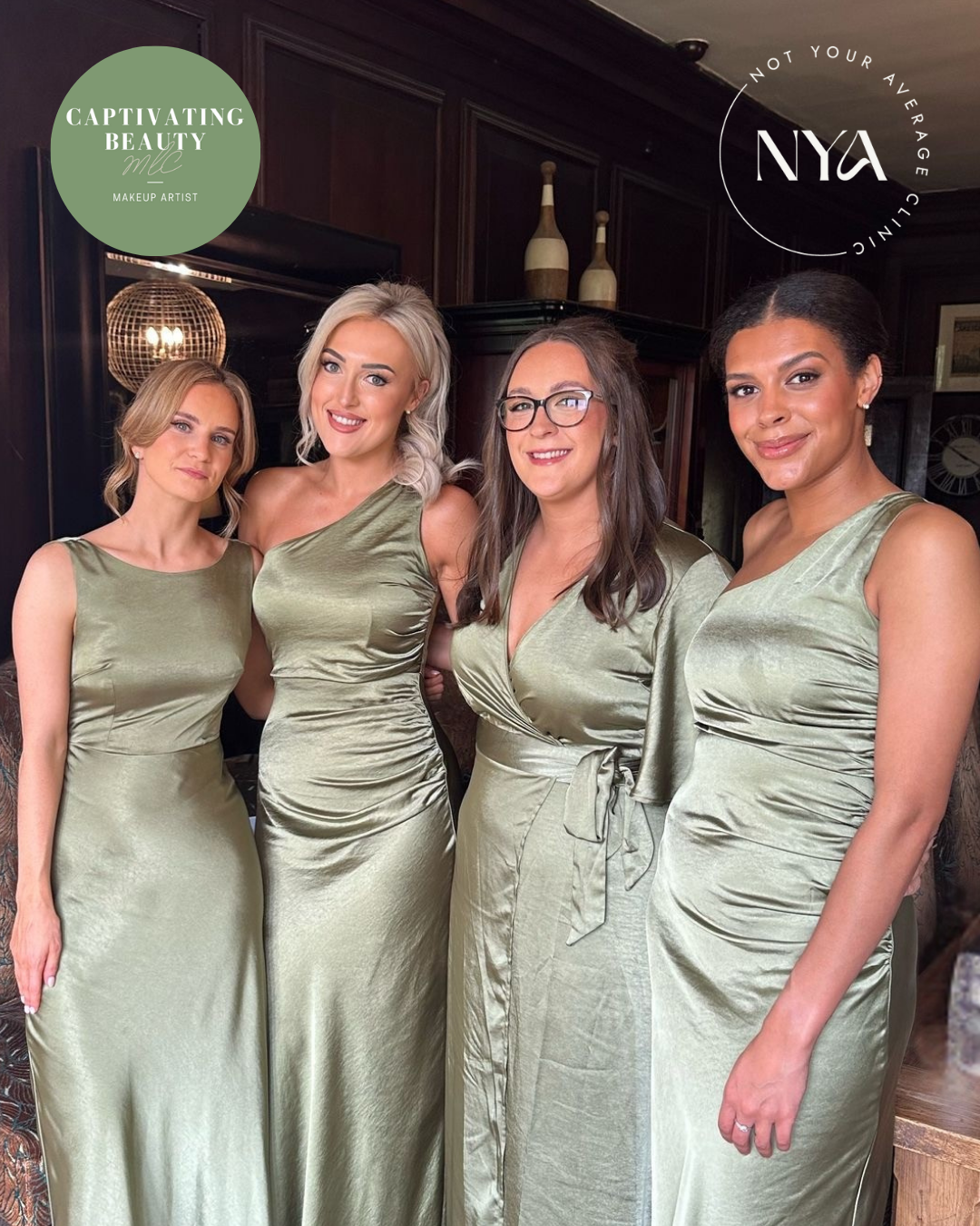 Four women wearing matching sage green dresses in an elegant room with wooden paneling and decorative bottles.