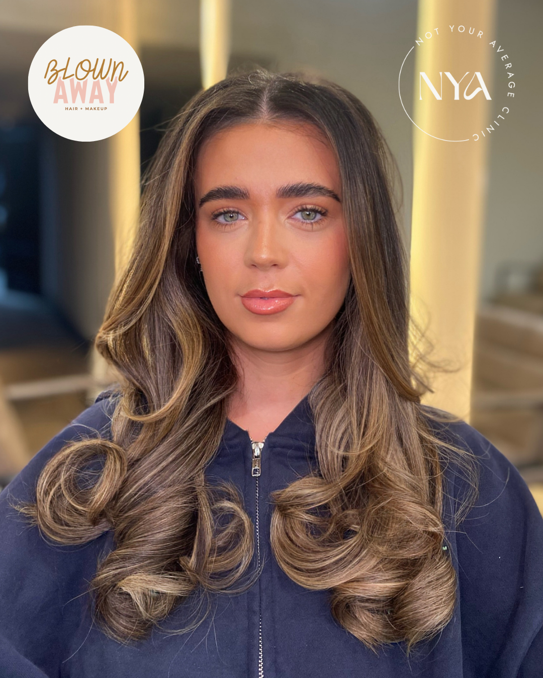 Woman with long, styled hair in a salon setting, wearing dark clothing. Text overlays read "Blown Away Hair Makeup" and "Not Your Average Clinic NYA."