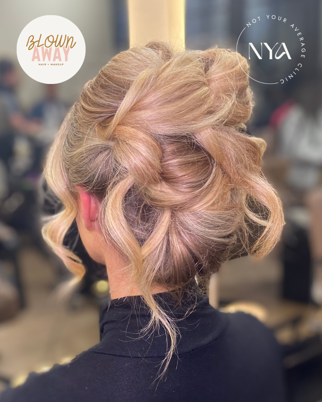 Elegant updo hairstyle with blonde hair, styled for a formal occasion, with salon branding in the background.
