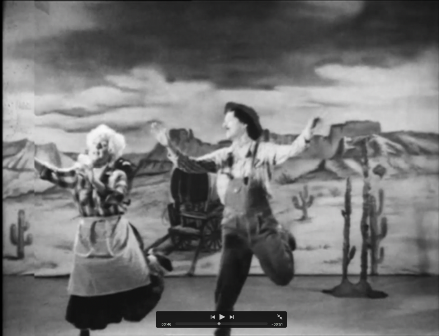 Cowby/girl dancing in front of waggon