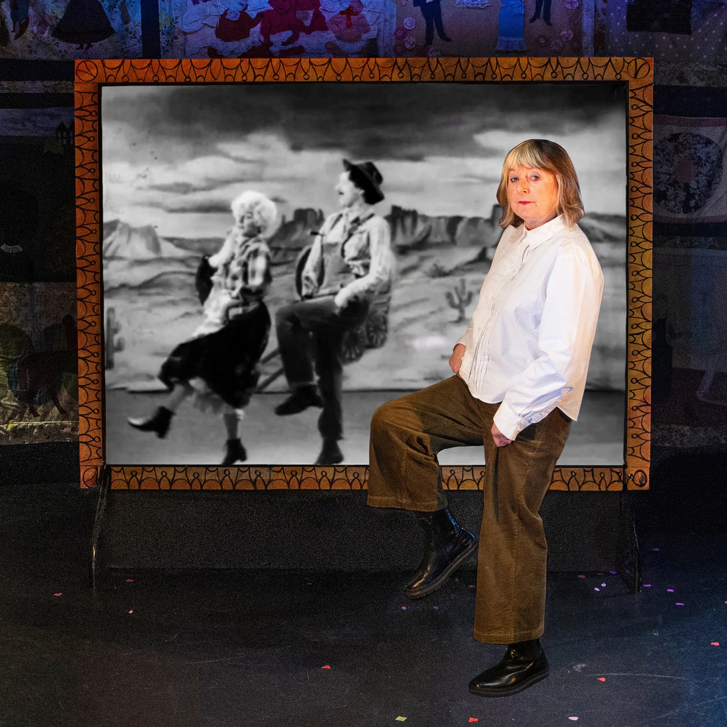 Sue dances with a black and white projection of herself and Maggie dressed as cowboys