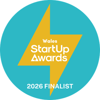 A circular logo with a yellow lightning bolt in the center and a blue background. Text on the logo reads 'Wales Startup Awards 2026 FINALIST'.