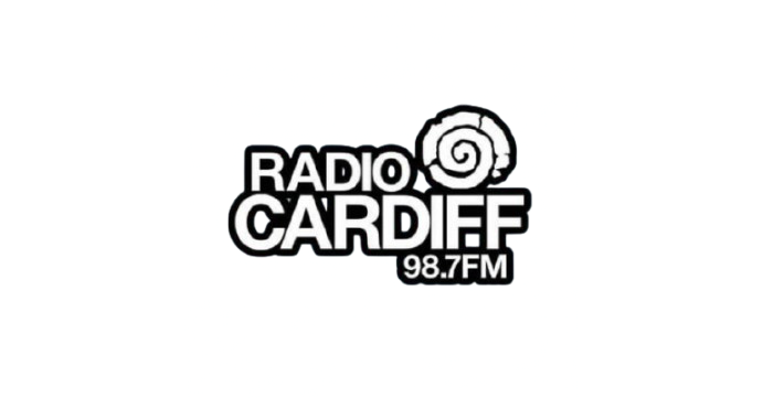 Radio Cardiff logo with a spiral shell graphic and frequency 98.7 FM on a textured light blue background.