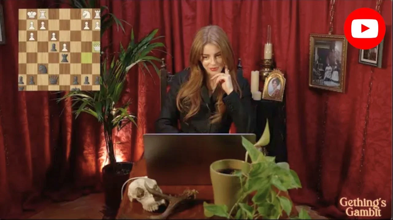 A woman with long reddish-brown hair and glasses, sitting at a desk with a laptop, surrounded by plants, candles, and framed pictures, with red curtains in the background. An overlay of a chess game is visible in the upper left corner. The logo for Ggetting's Gambit is in the bottom right corner.