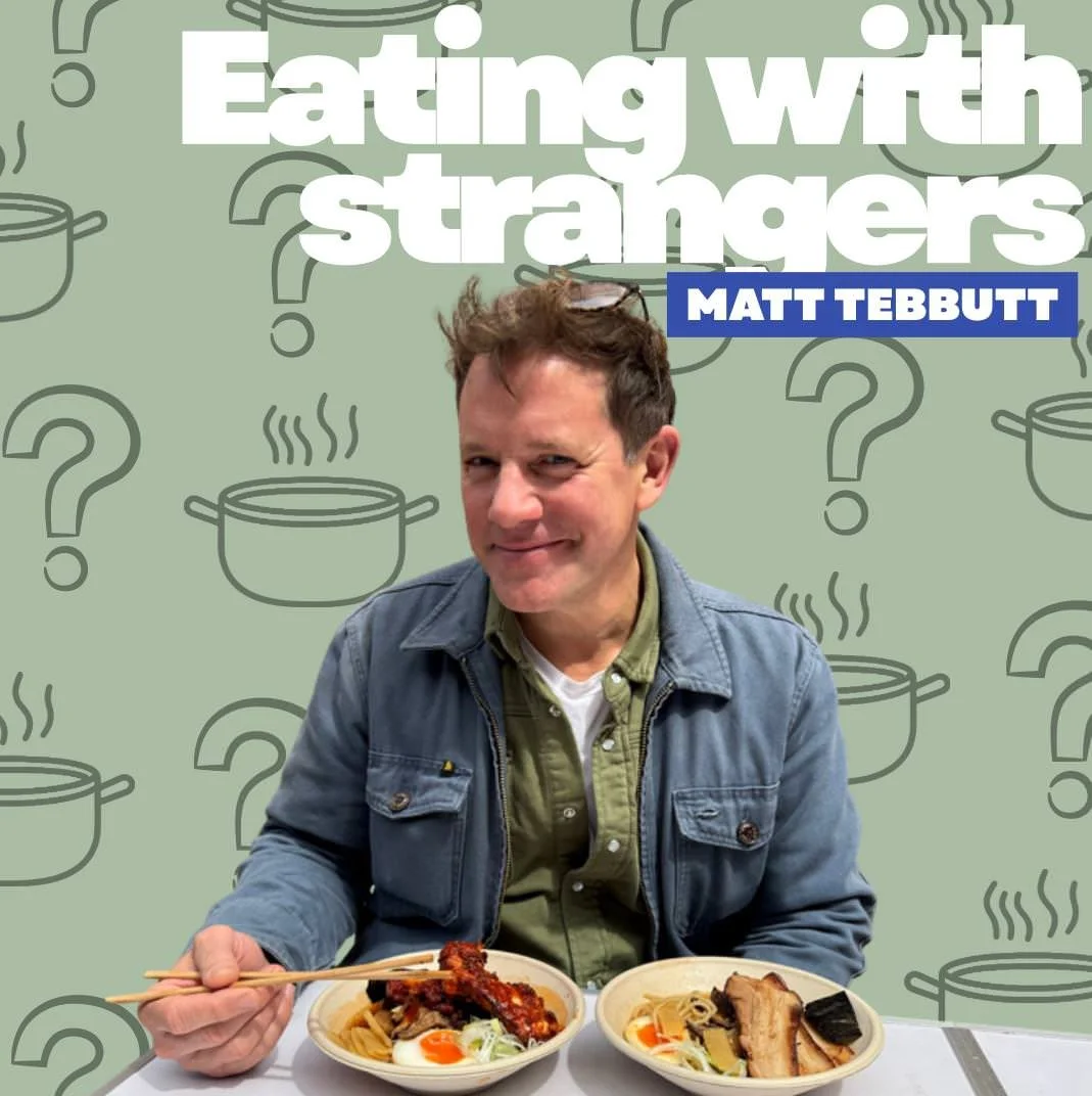 A man sitting at a table with two bowls of ramen, holding chopsticks with a piece of meat, smiling. The background has a green pattern with cooking pots and question marks, with text that reads 'Eating with strangers' and 'Matt Tebbutt'.
