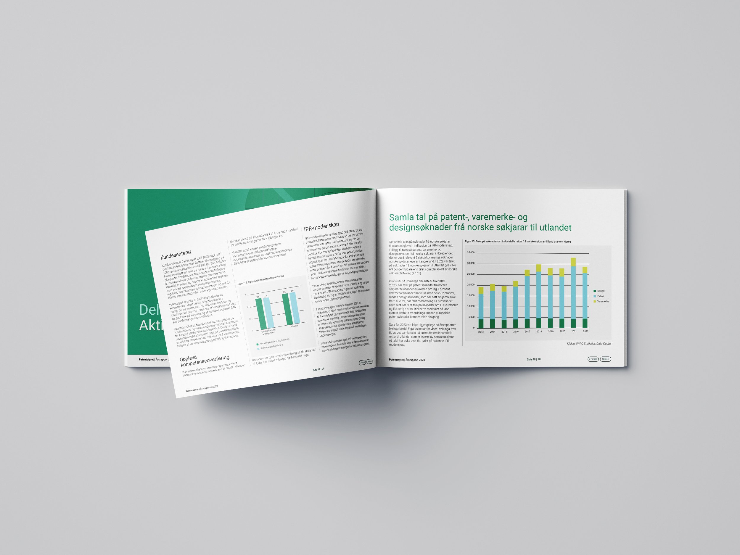 Open book on a gray surface with text and charts in a foreign language.