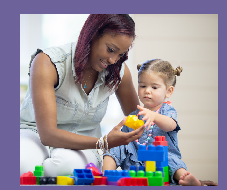 Woman and young girl playing with colorful building blocks indoors.