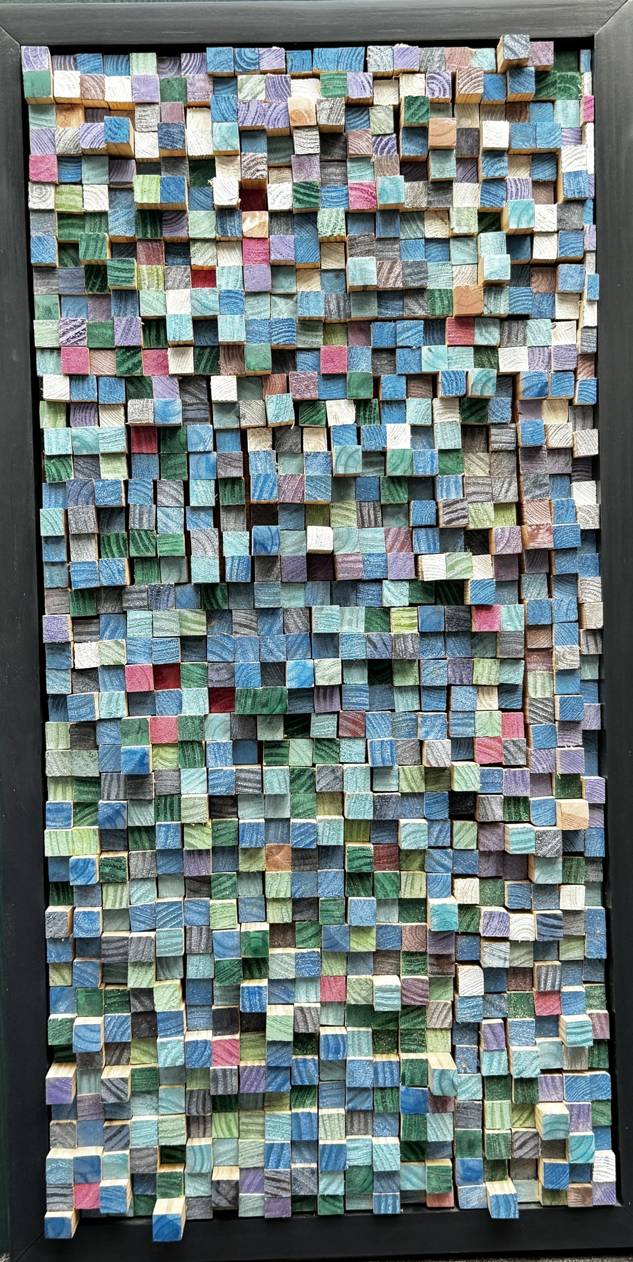 Colorful wooden cubes arranged in a grid pattern with a black border.