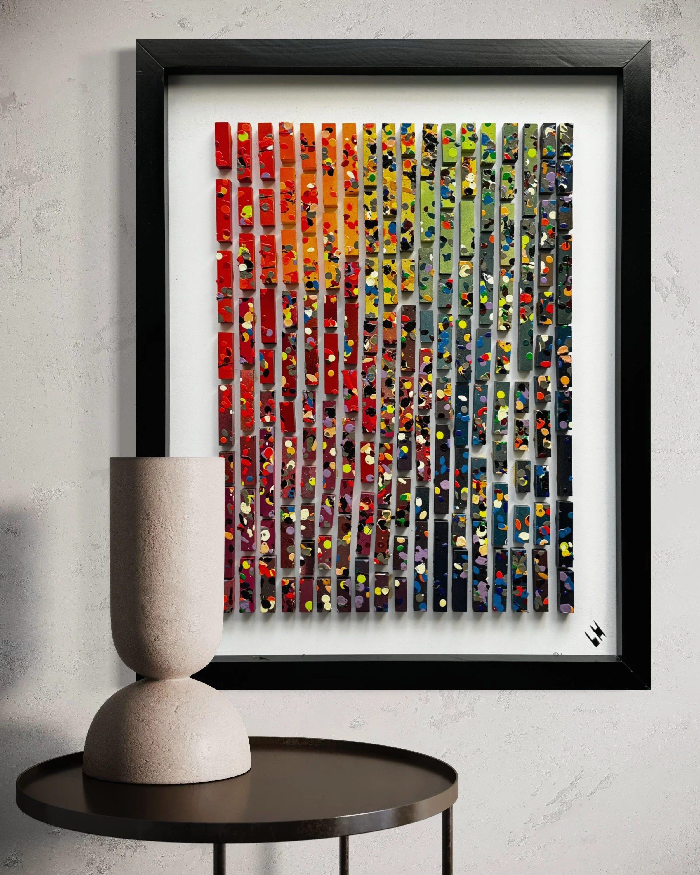 Colorful abstract artwork with vertical rectangular pieces mounted on a wall.