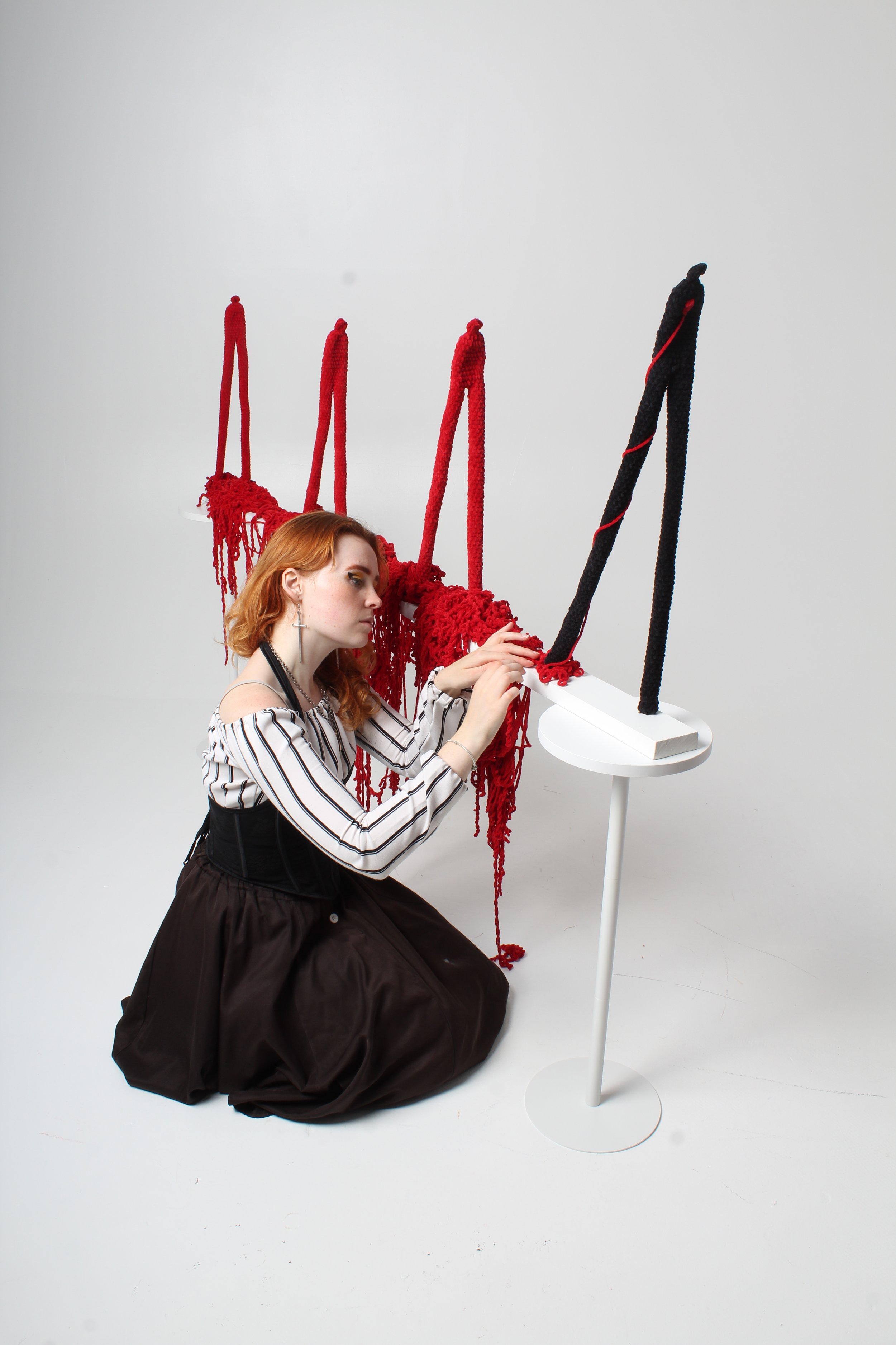 Ceris Dyfi Jones, textile artist, working on a sculpture named 'Yr Hyn Sy'n Dilyn / What Follows' to be exhibited in Caernarfon Castle as part of her Heartstrings crochet series.