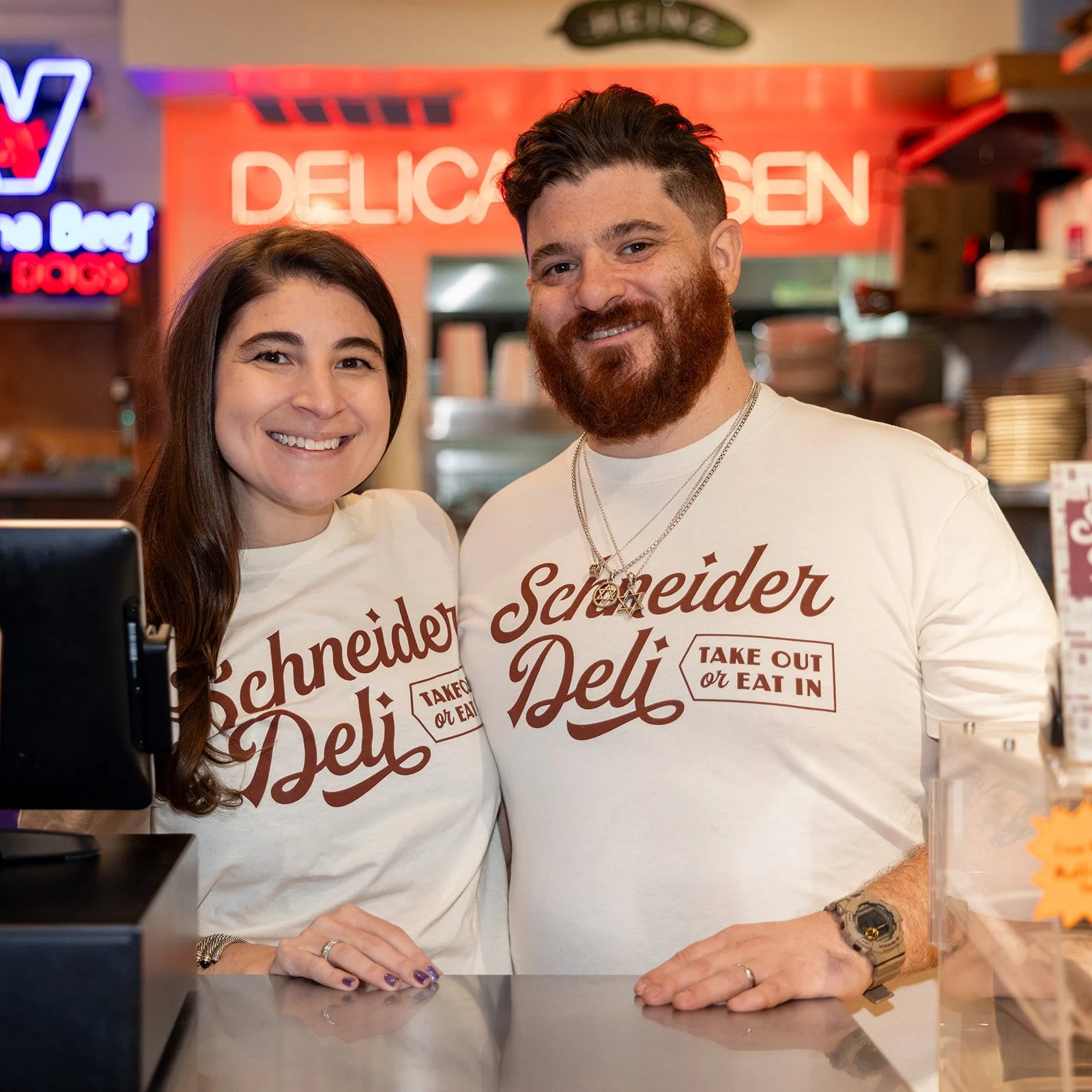 From above hands of unrecognizable woman rubbing aromatic spices into piece of raw meat over parchment paper