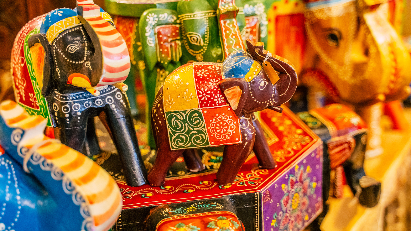 Colourful, vibrant handmade elephant sculptures decorated with painted dots, motifs, stripes and blocks.