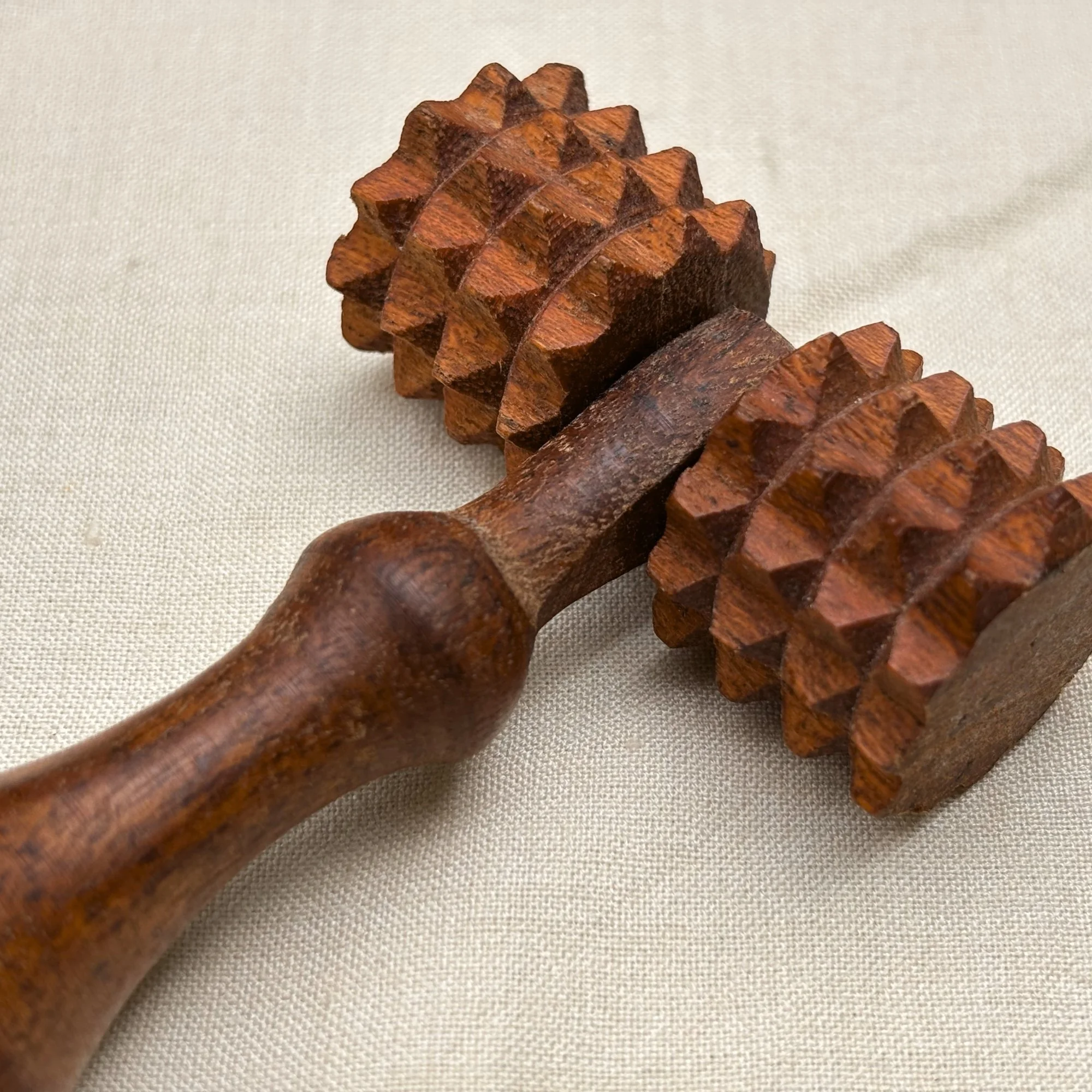 Wooden_deep_tissue_massage_roller_closeup.jpg