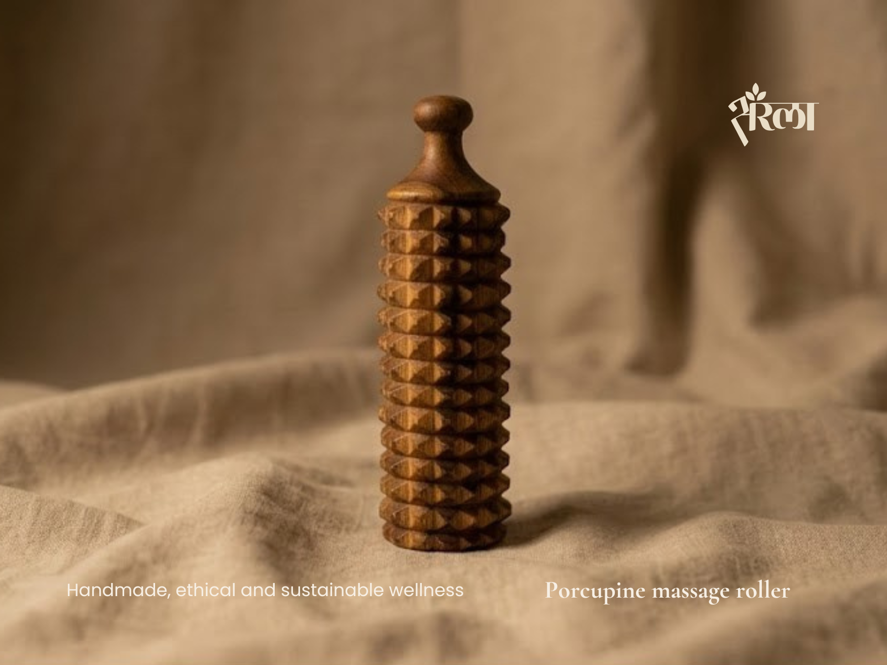 Handmade wooden Porcupine massage roller standing on linen with warm natural texture