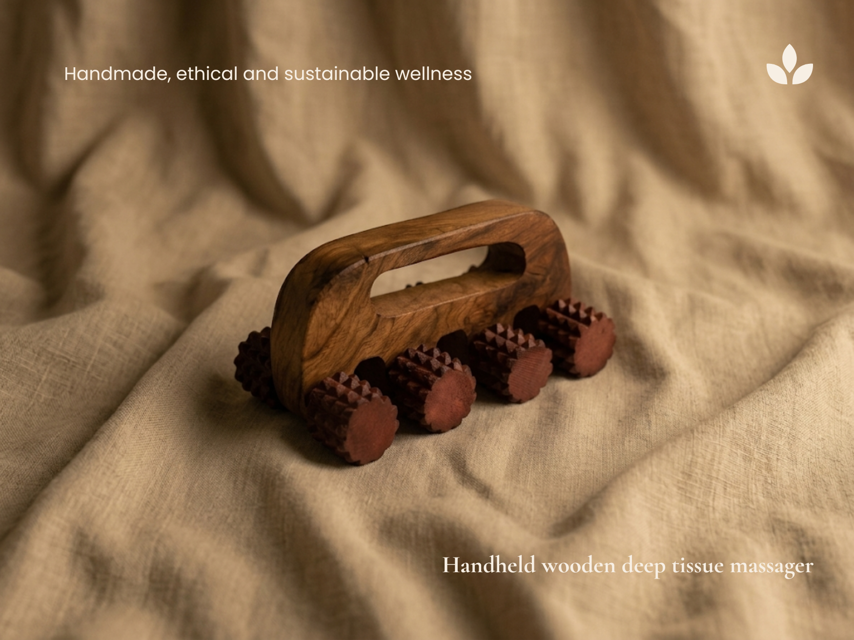 Handheld wooden deep tissue massager displayed on natural fabric