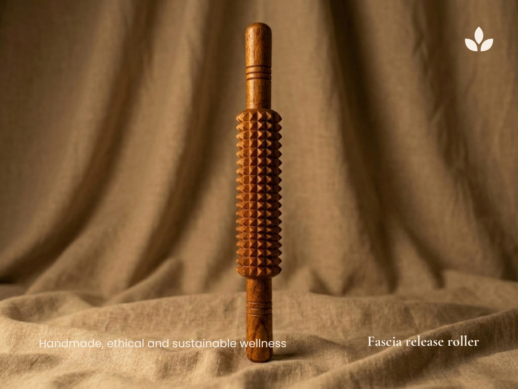 Handmade wooden fascia release roller displayed upright on natural fabric with sustainable wellness branding.